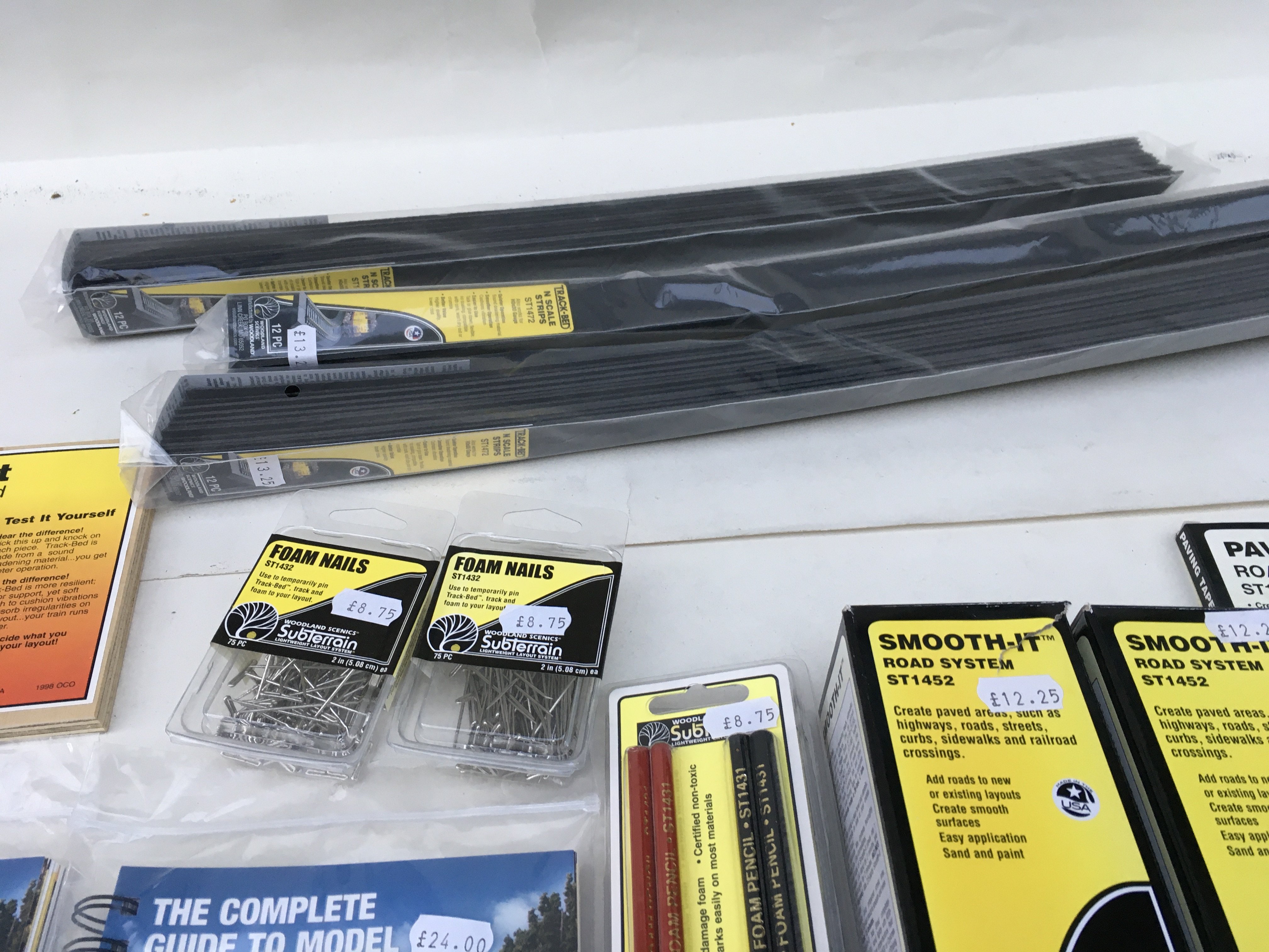 A collection of Woodland Scenics accessories including track bedding and profile boards. Also includes books The Complete Guide To Model Scenery. No reserve