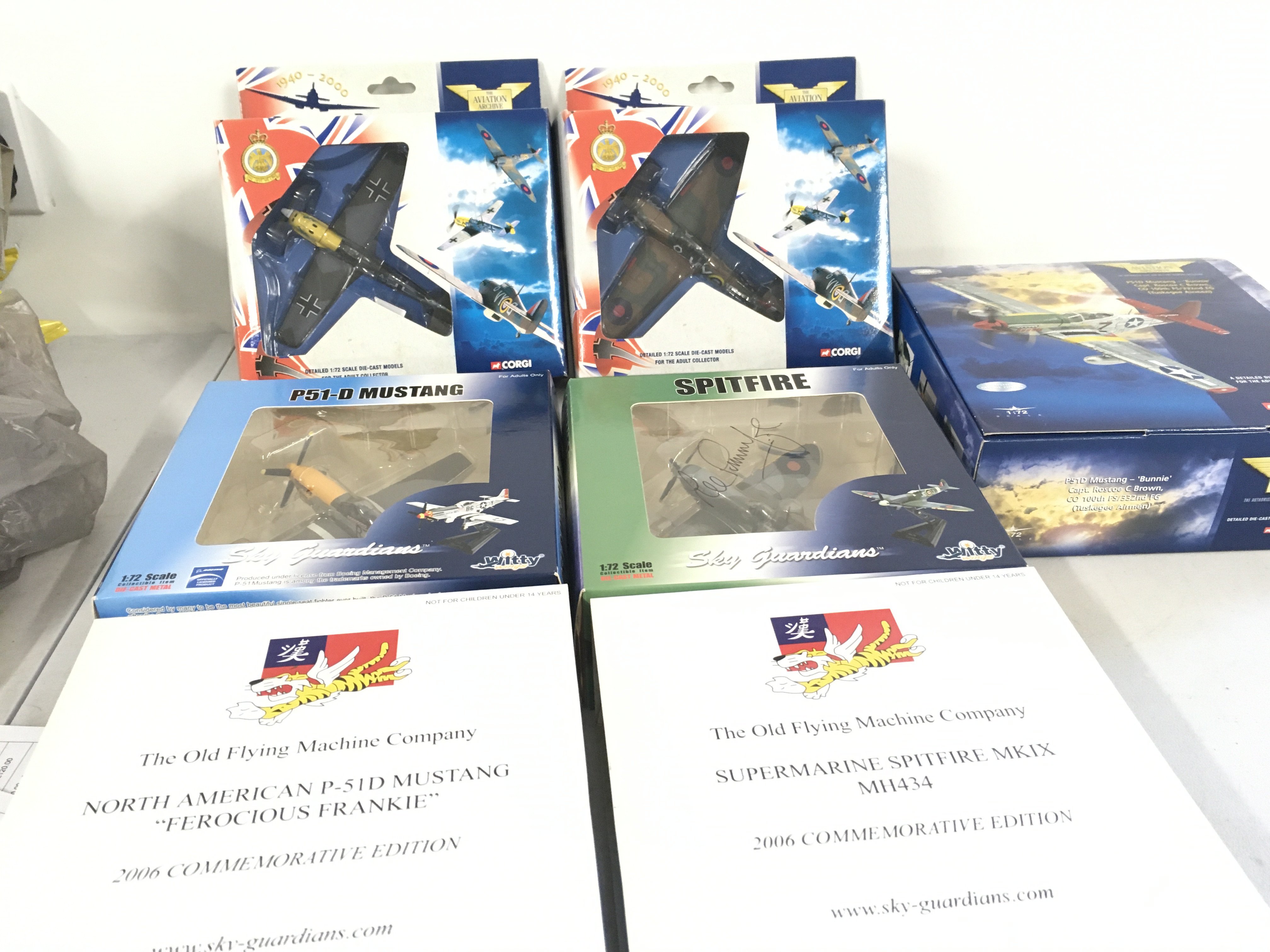 A collection of 5 military model aircraft in the original display packaging by Corgi and Witty Wings. Of note in this lot the 2006 commemorative Spitfire has been signed .
