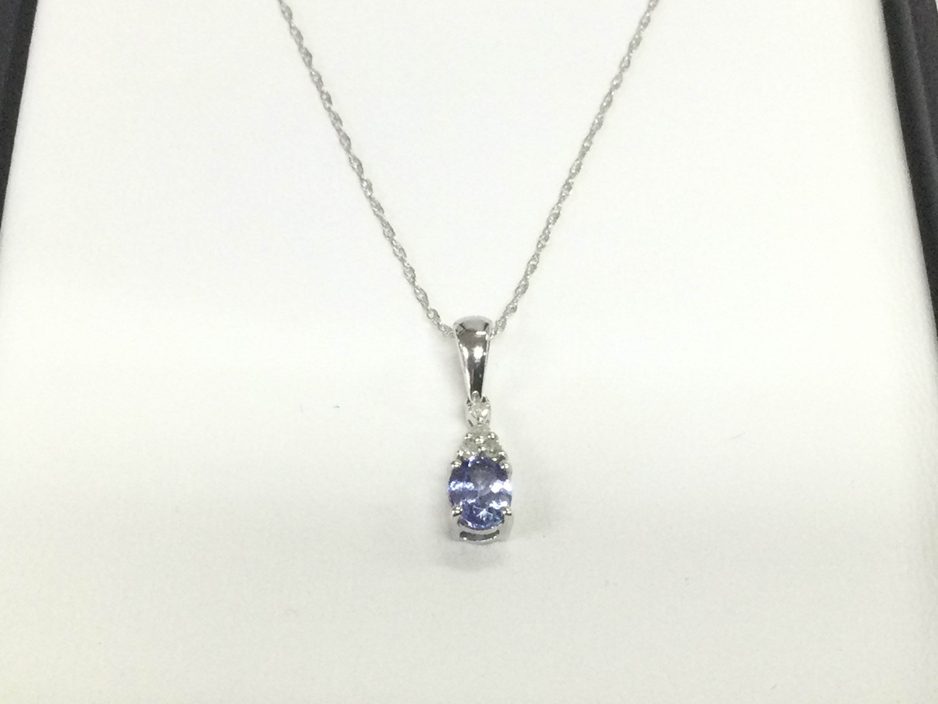 A 9ct white gold pendant set with small diamonds and tanzanite, approx 1g. Shipping category A.