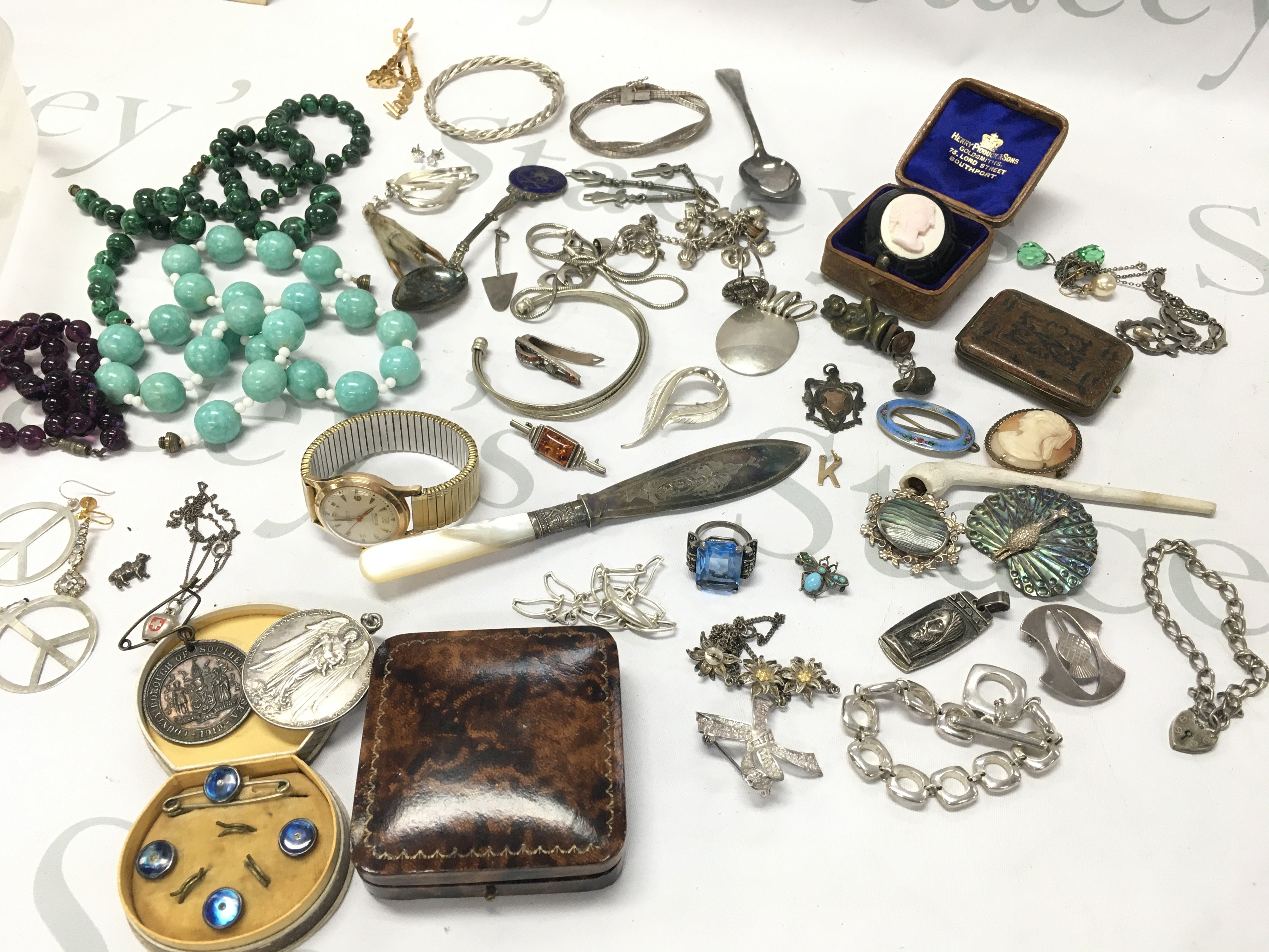 A collection of costume Jewellery including silver pieces such as bracelets, rings , brooches etc , coral jet brooch, 9ct gold K initial pendant, Portuguese medal . Postage category B