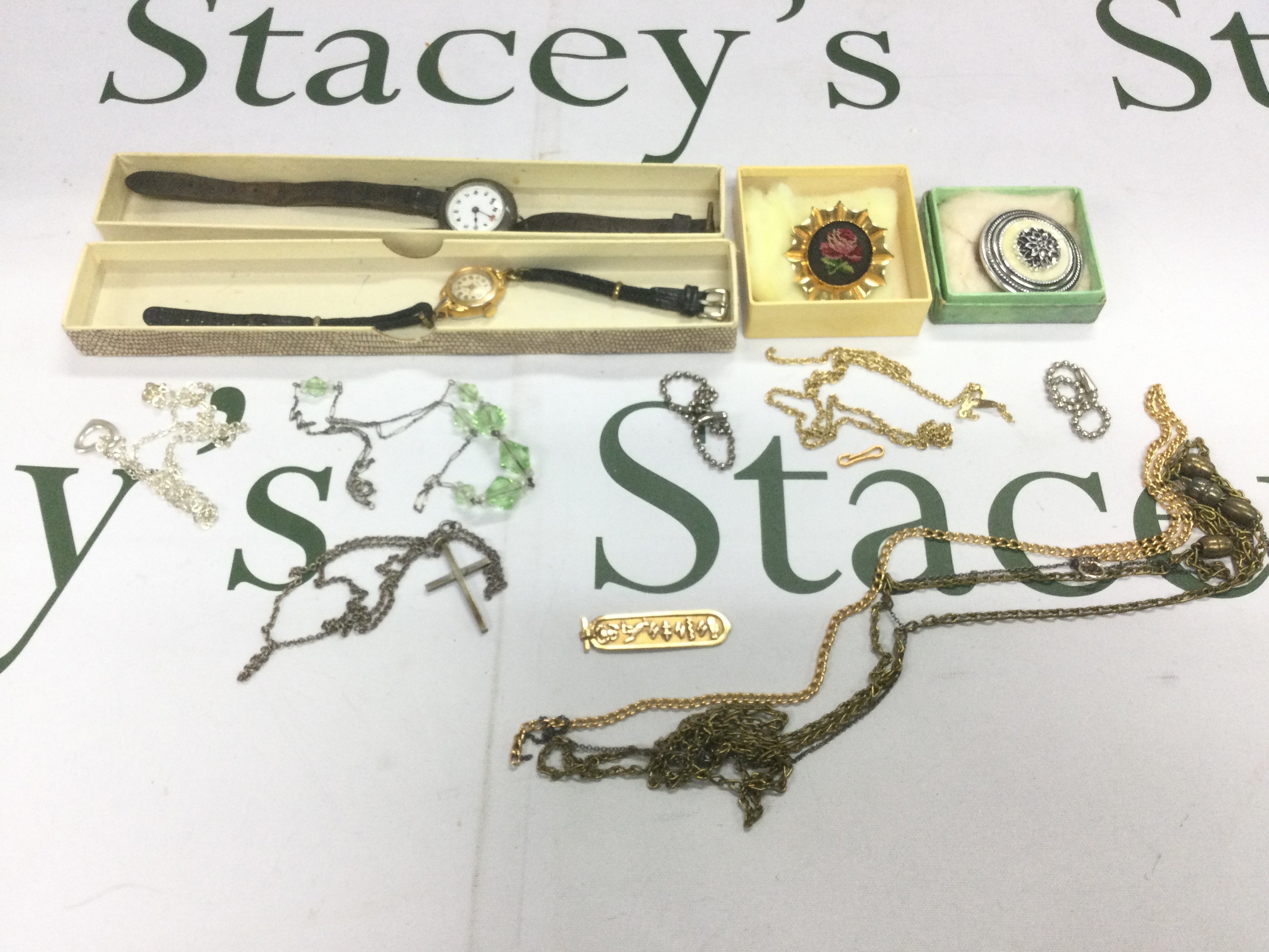 A collection of costume jewellery to include a high carat gold Egyptian cartouche pendant, various chains, two watches etc. Shipping category B.