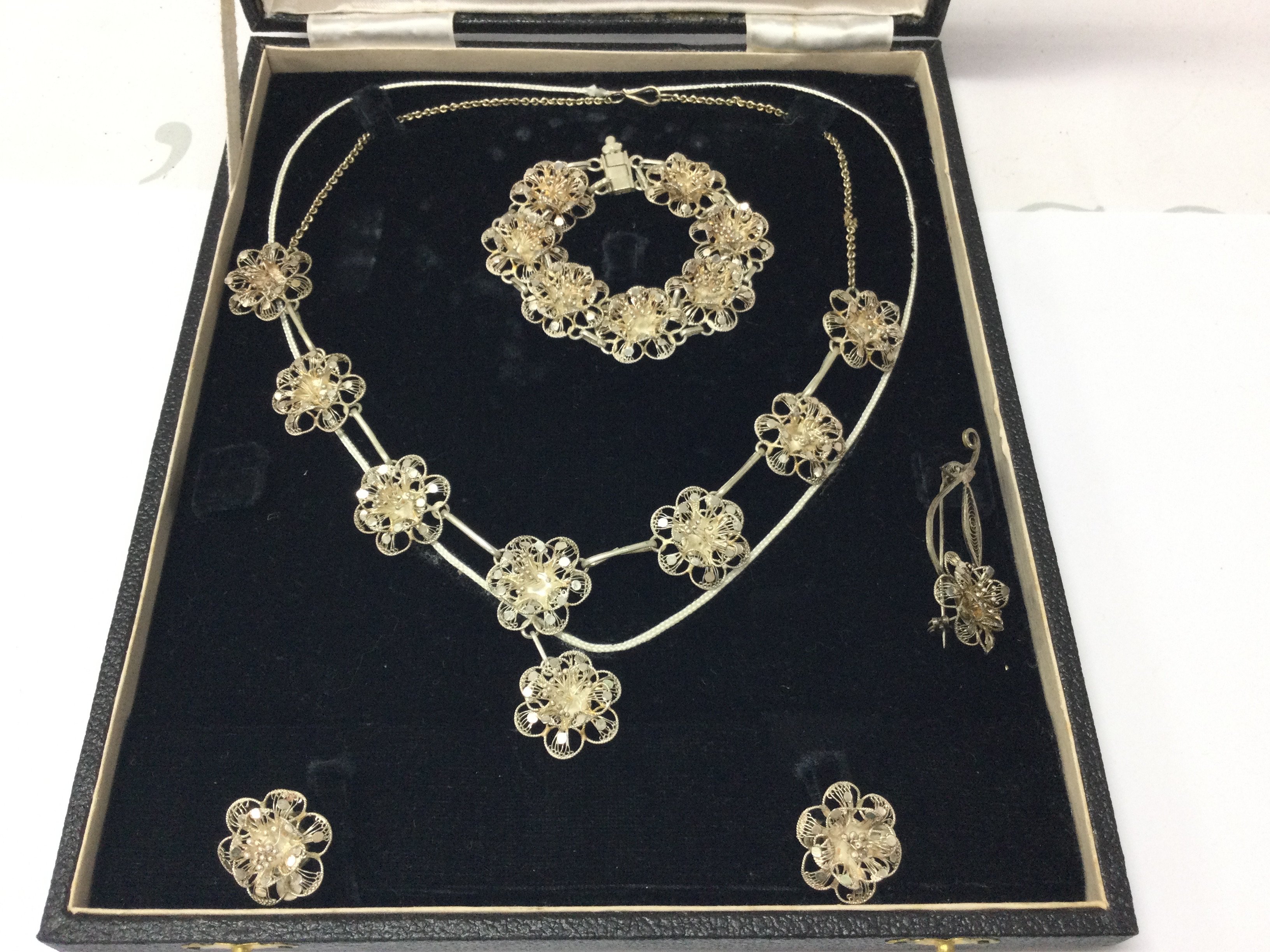 A silver filigree jewellery set including necklace earrings brooch and bracelet. Postage B