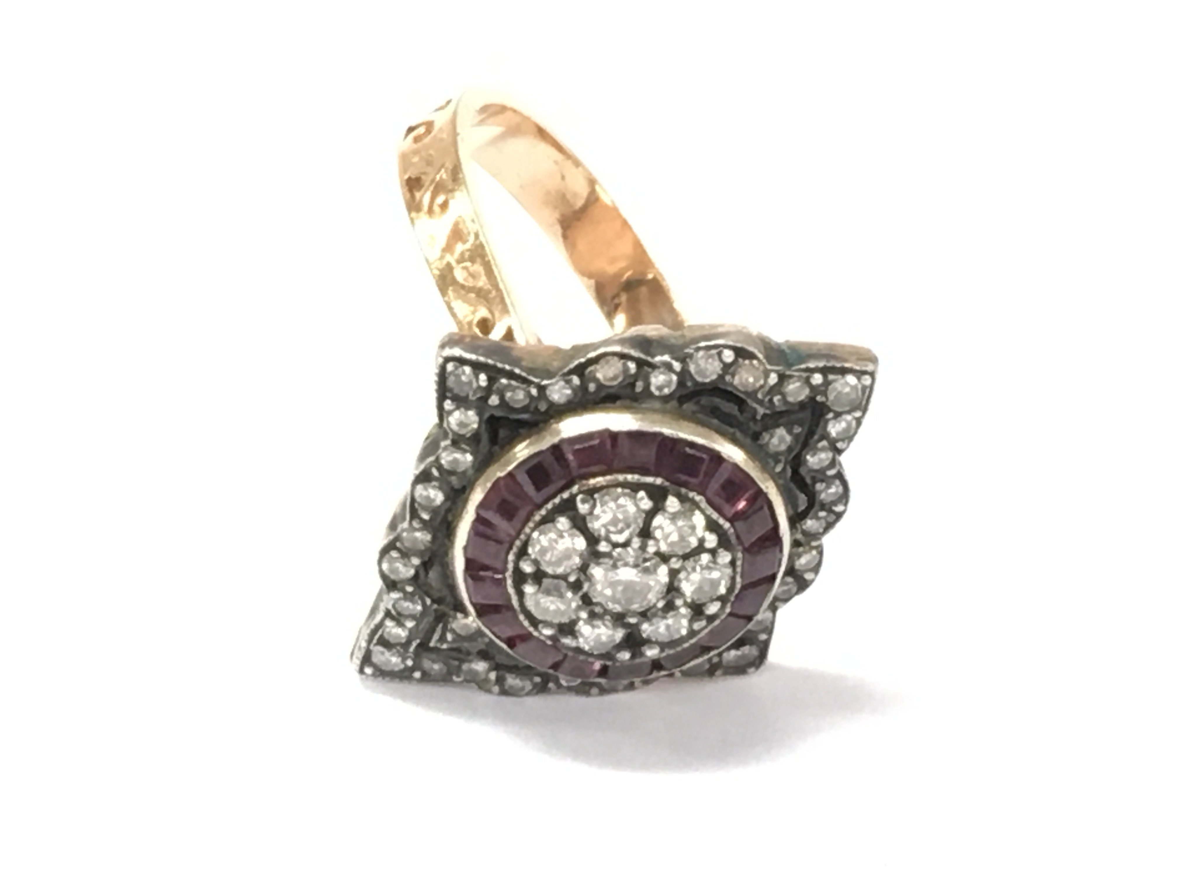 An unhallmarked Georgian style rose gold marquise shaped ring set with diamonds and calibre cut rubies. Diamonds 0.55ct and rubies 0.38ct Approx. Size O 1/2.