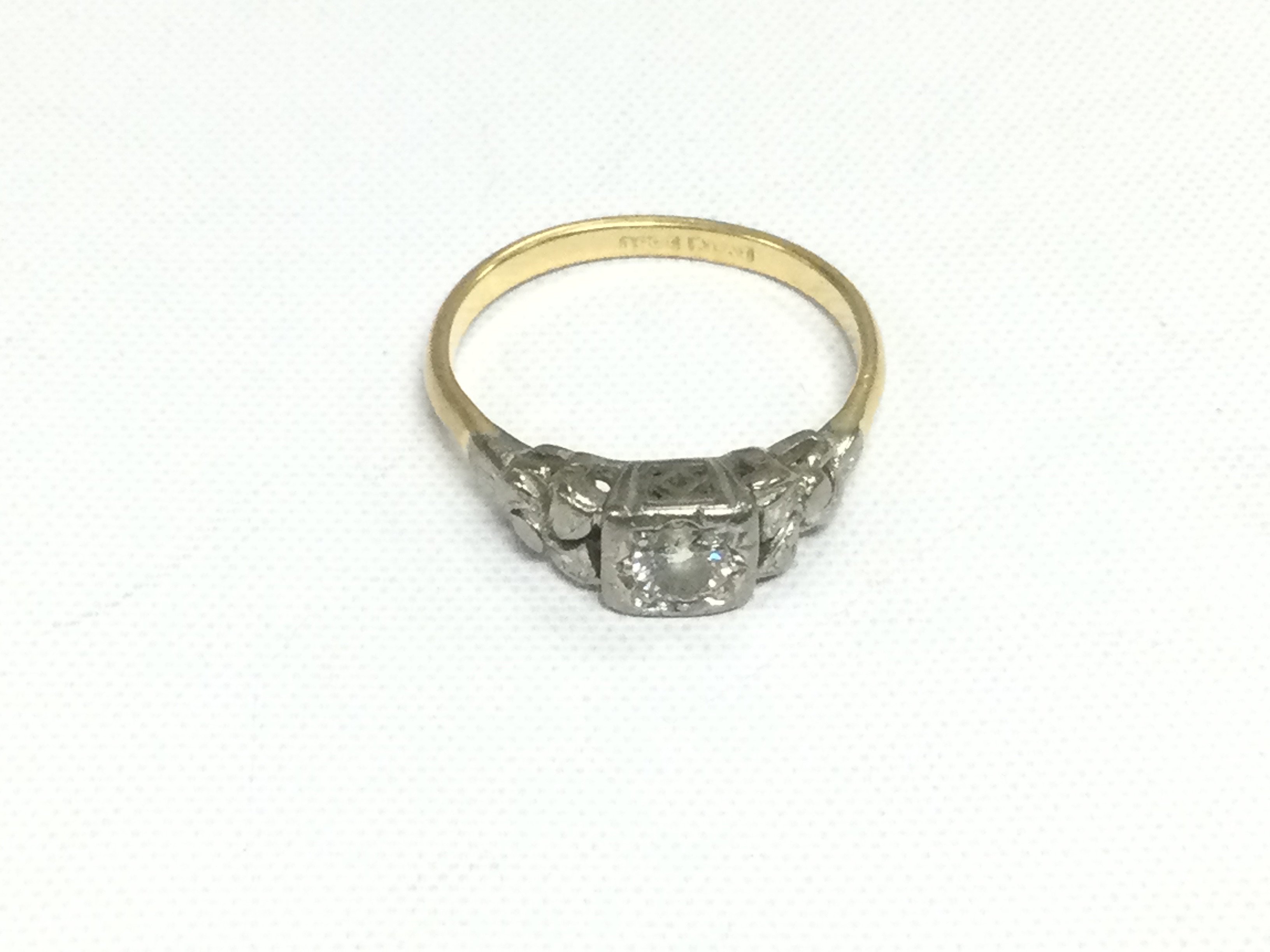 An 18ct gold and platinum diamond solitaire ring, approx 3g. Shipping category A.