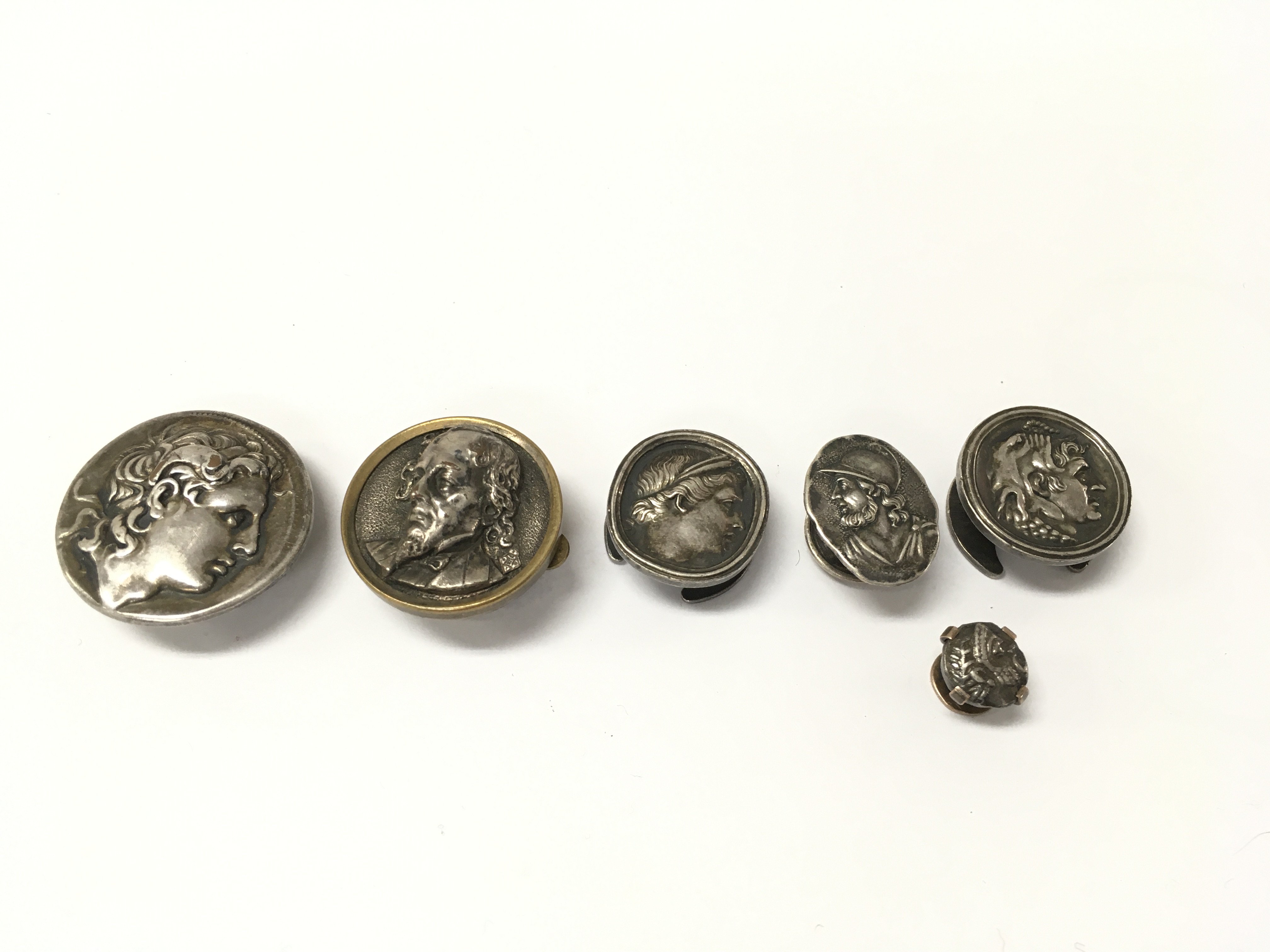 Collection of antique buttonhole and silver studs including a 19th century stud depicting a classical male figure. Postage B