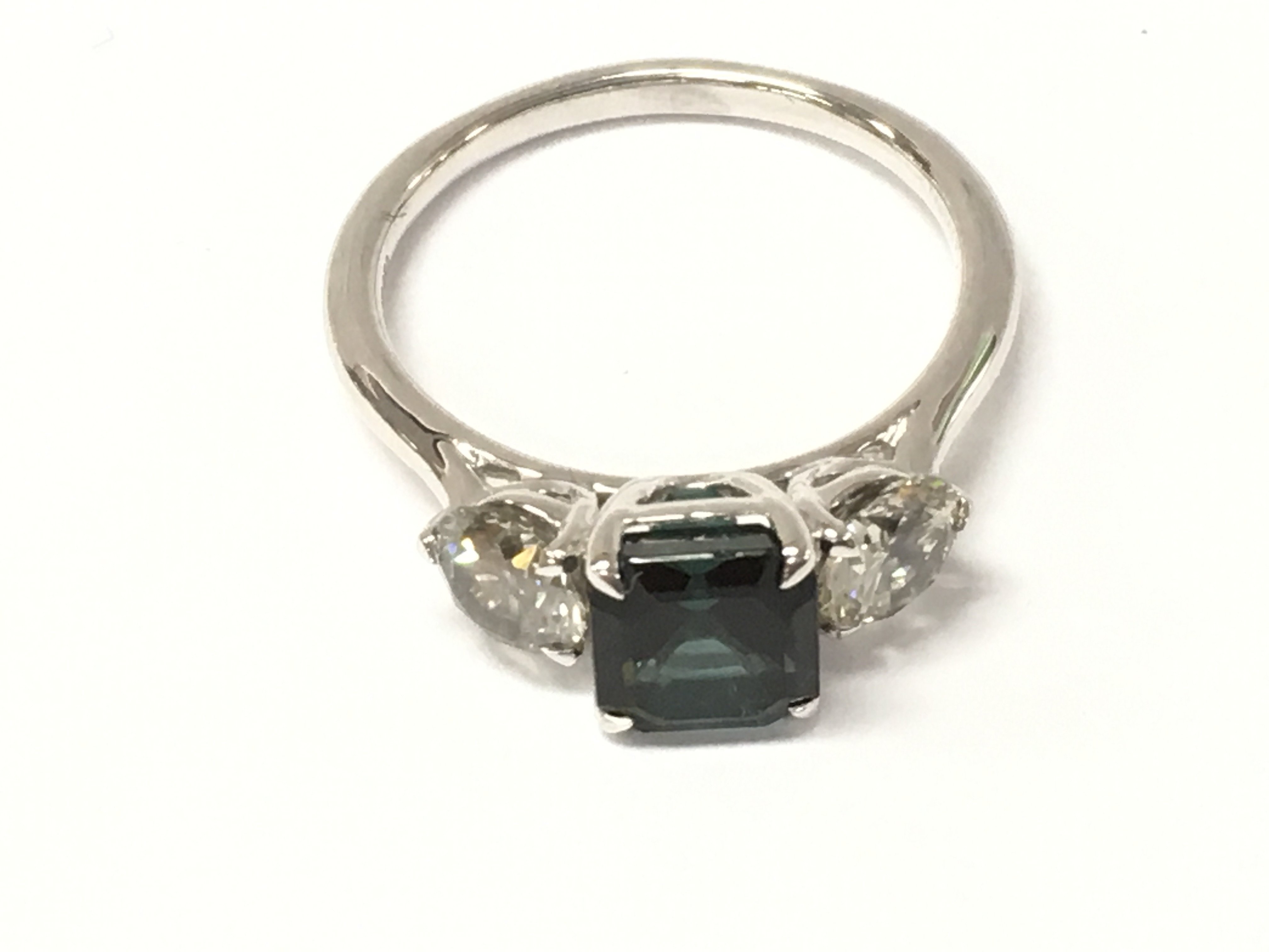 A platinum 3 stone ring set with step cut parti tourmaline flanked diamonds. Tourmaline 1.65ct and diamonds 1.05ct. Size N