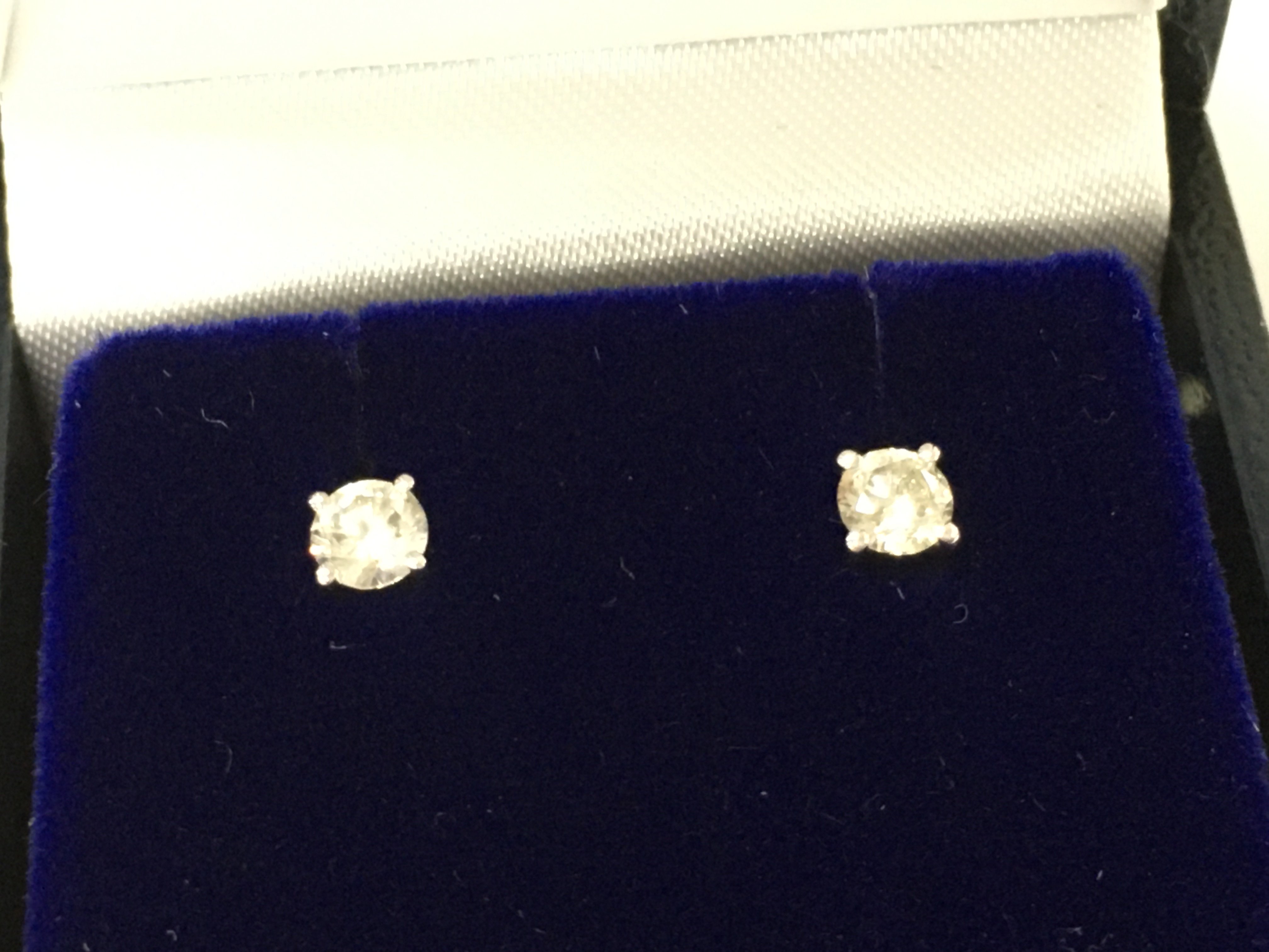 A pair of platinum solitaire diamond studs Diamonds approx 0.38ct total. Postage B