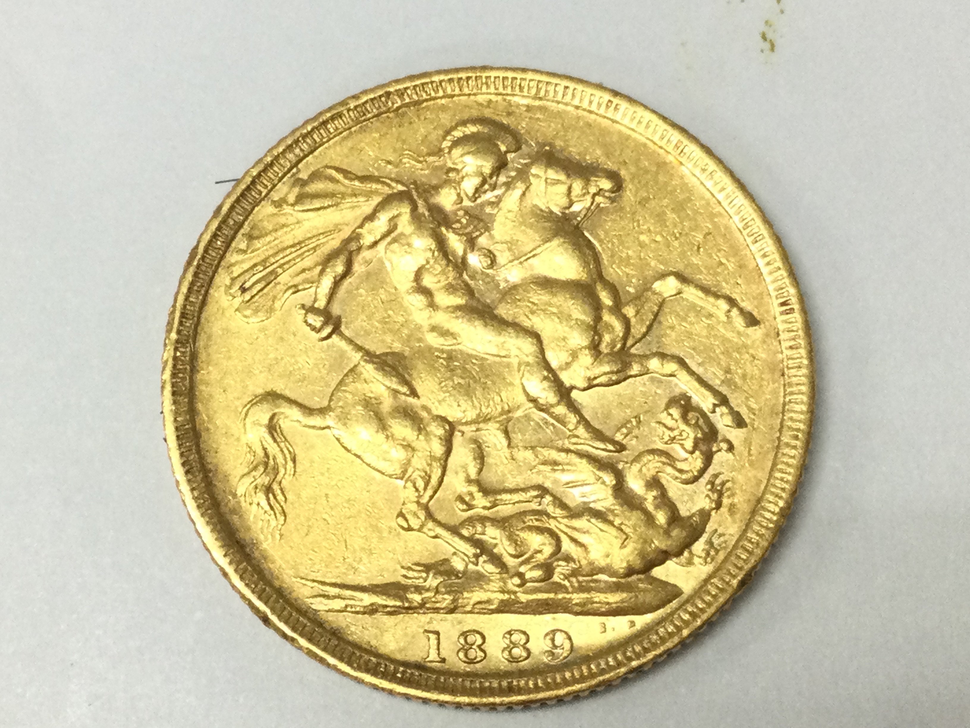 A 1889 full sovereign. Postage A