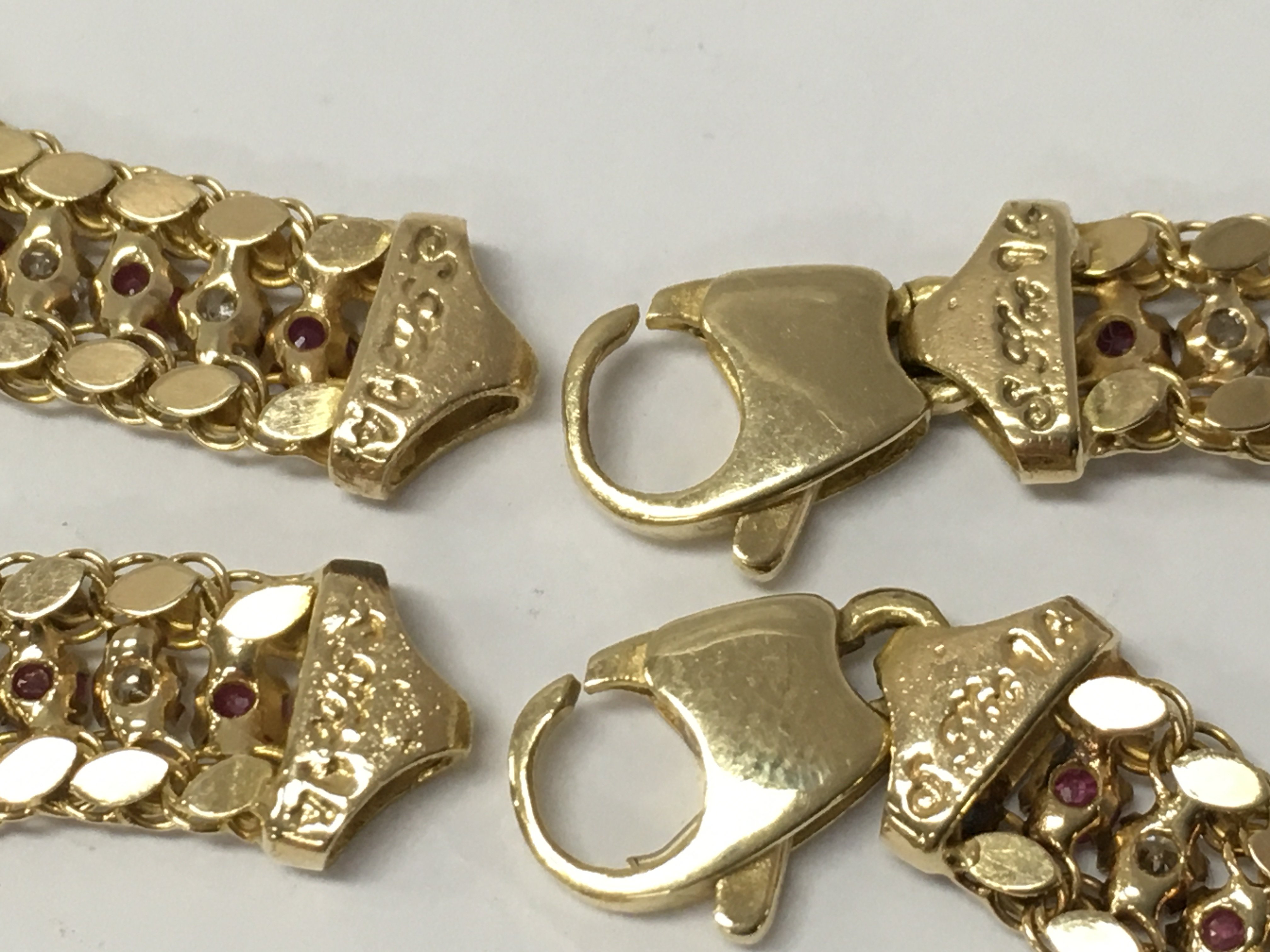 14 carat gold ruby and diamond set necklace and matching bracelet , 34g total weight approximately. Postage category A