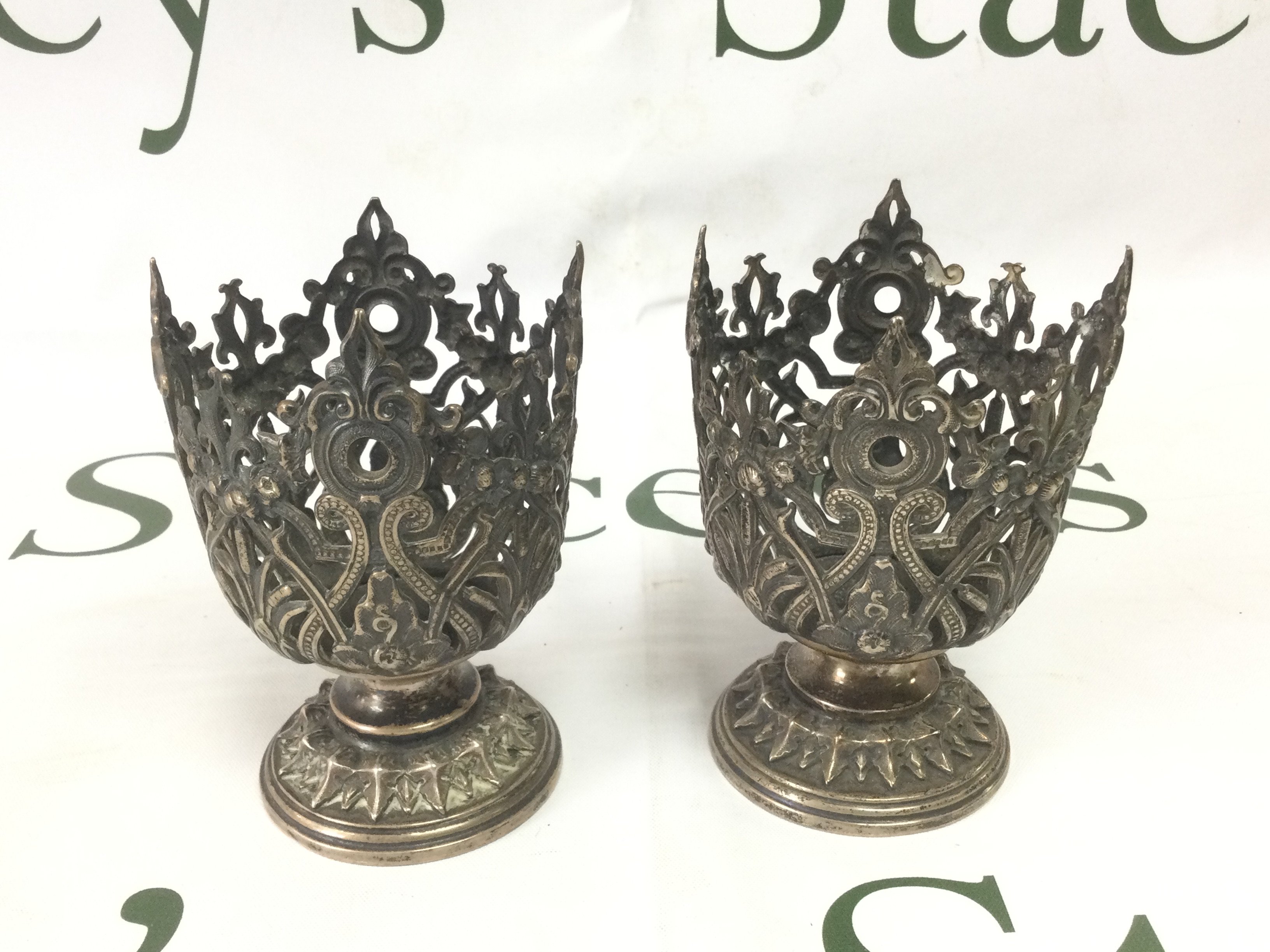 A pair of 900 silver candlesticks with elaborate piercework decoration, approx height 10cm. Shipping category A.