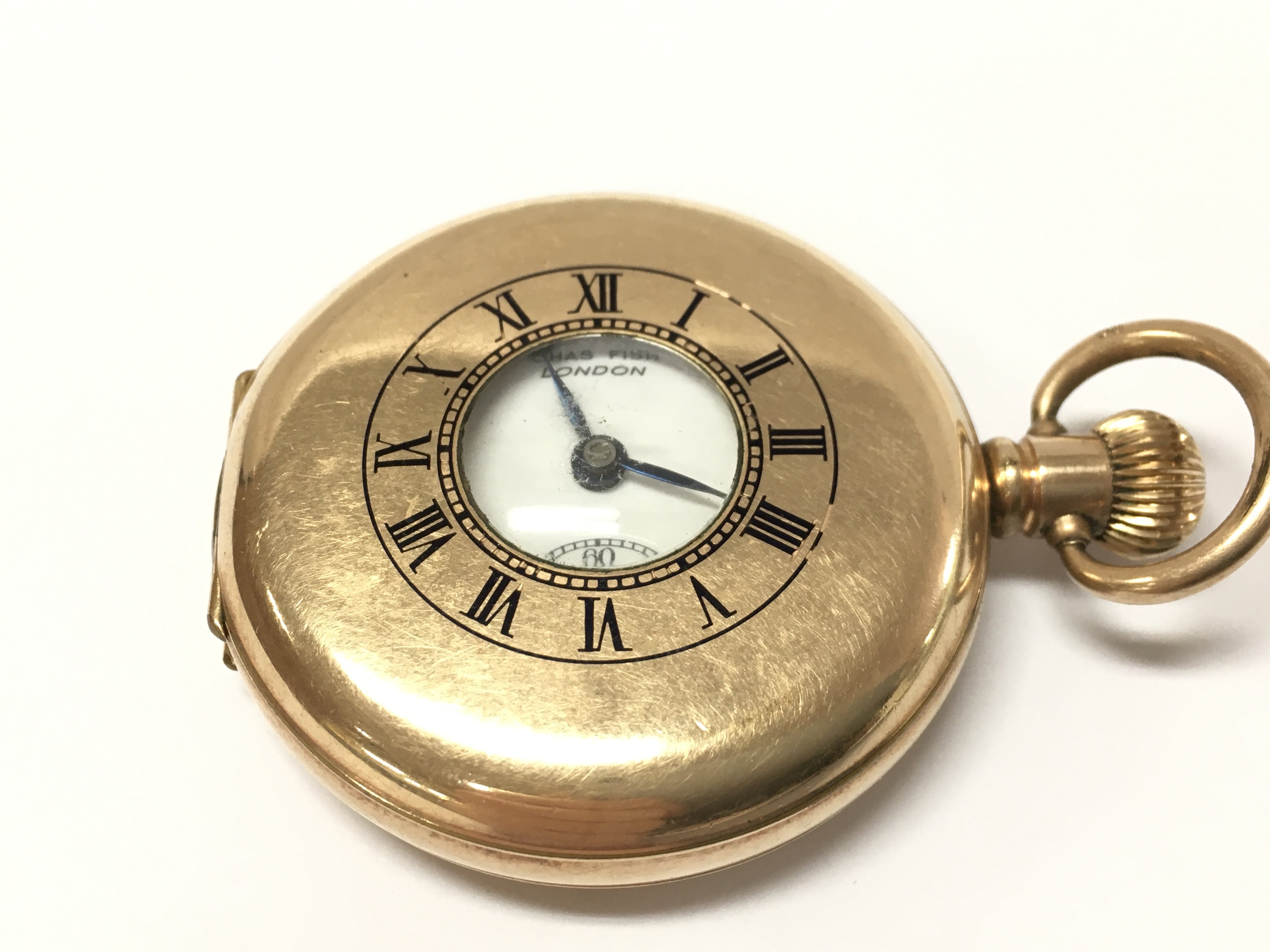 A gold plated pocket watch by Chas Fish London, seen working. Postage category A