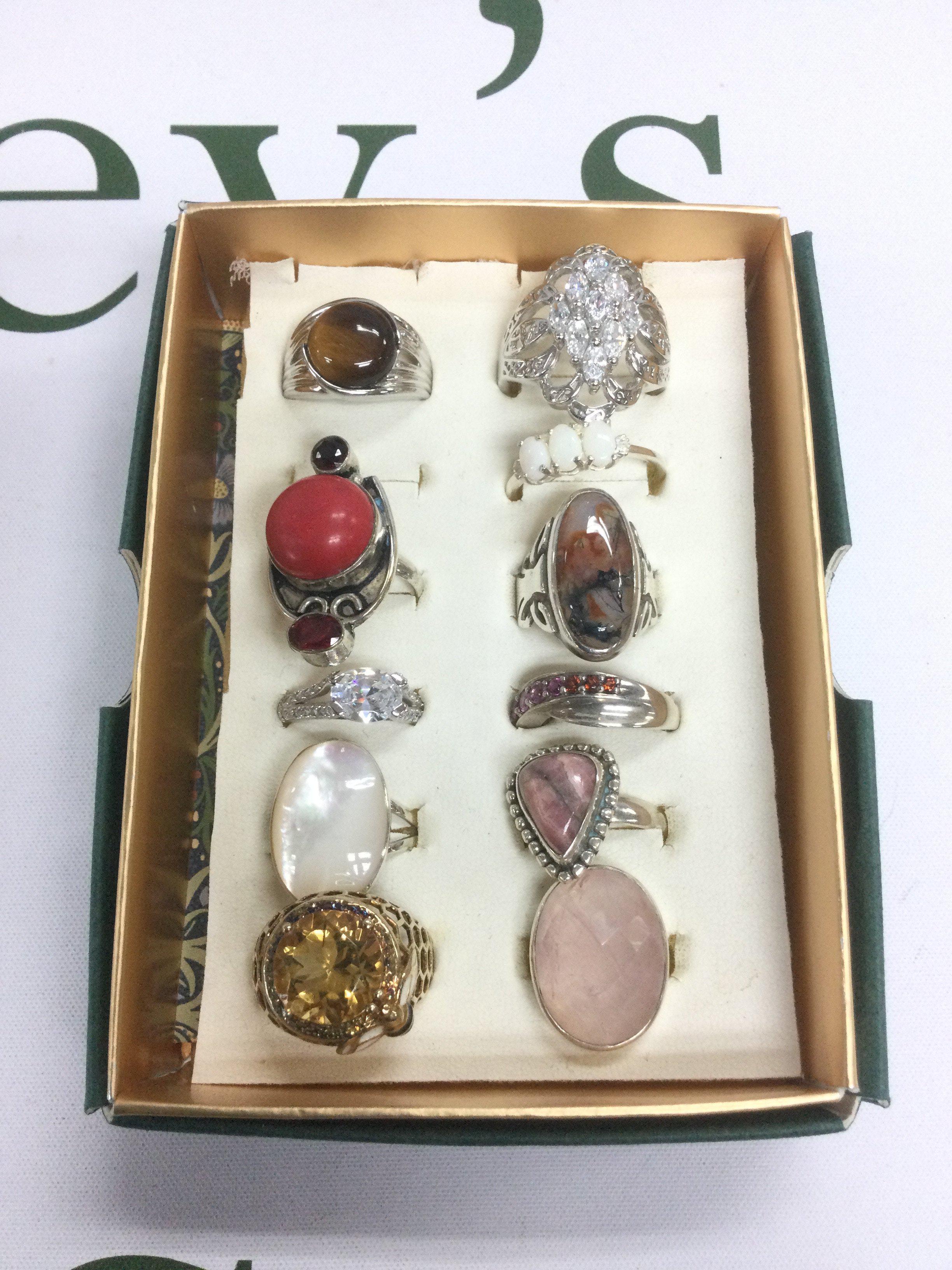 Eleven stone set silver rings. Shipping category B.