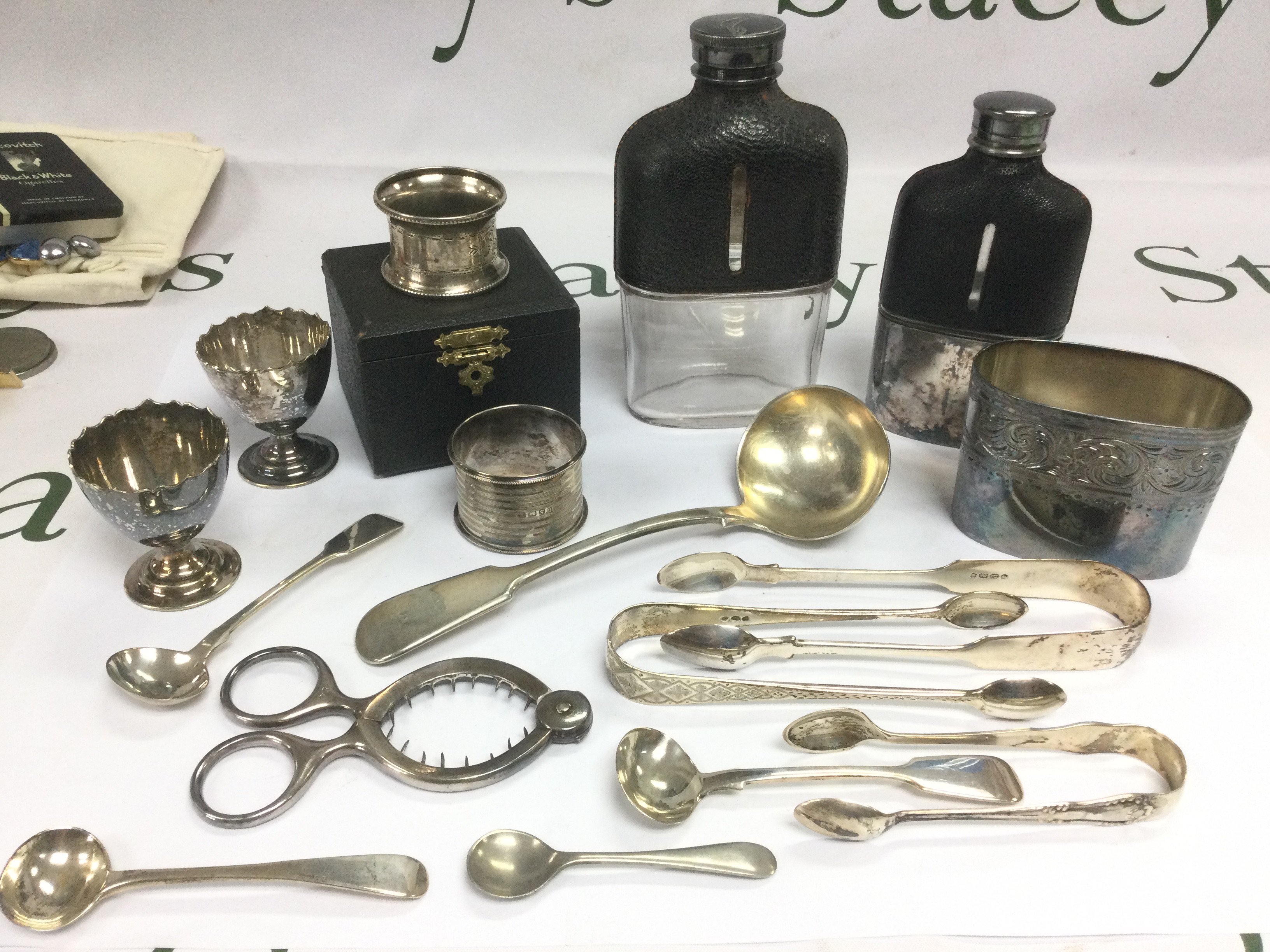 A collection of oddments comprising two hip flasks, napkin rings, silver cutlery, costume jewellery etc. Shipping category D.