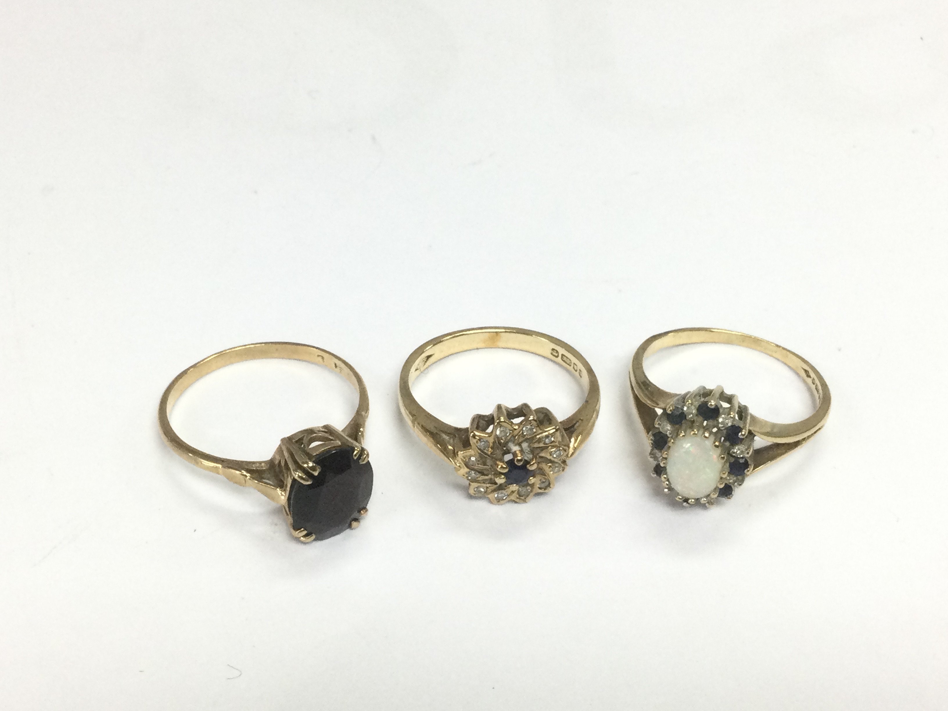 Three 9ct gold rings set with stones, approx total weight 7.5g. Shipping category A.