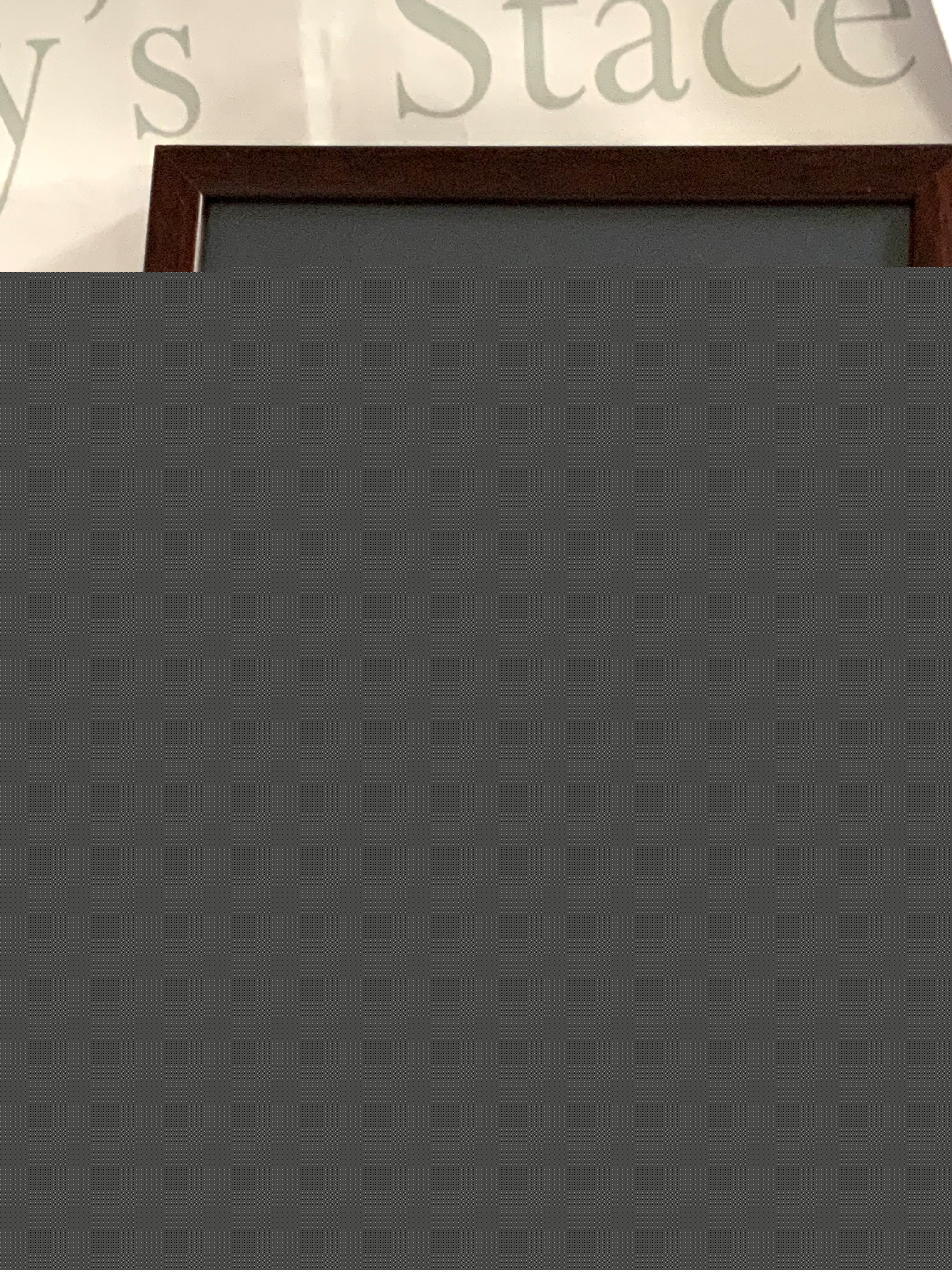 A framed set of hallmarked silver and enamel teaspoons together with a silver model of The Amy Crane Rose mounted on a wooden panel.