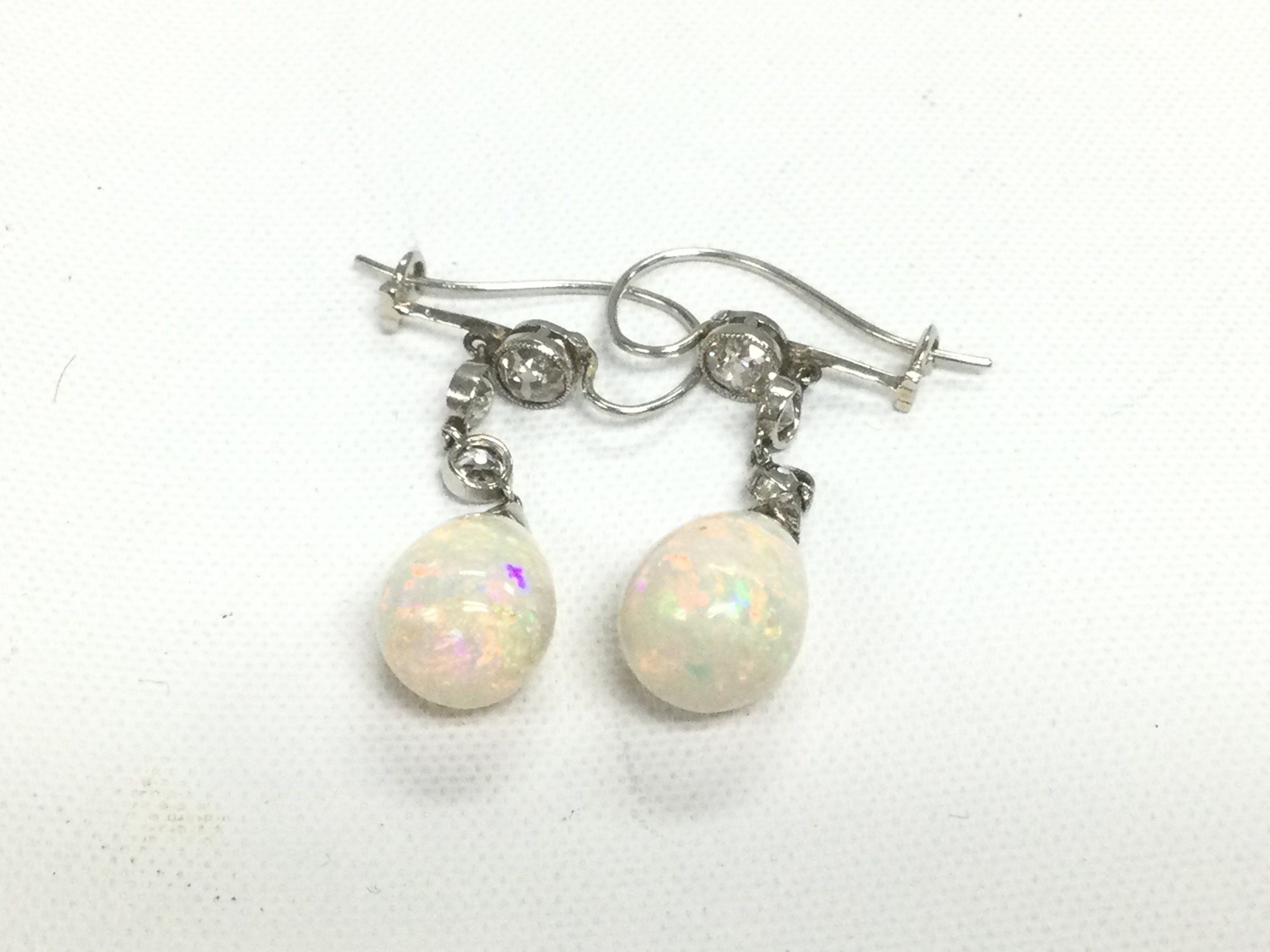 A pair of white gold diamond and opal drop earrings, approx 3.6g. Shipping category A.
