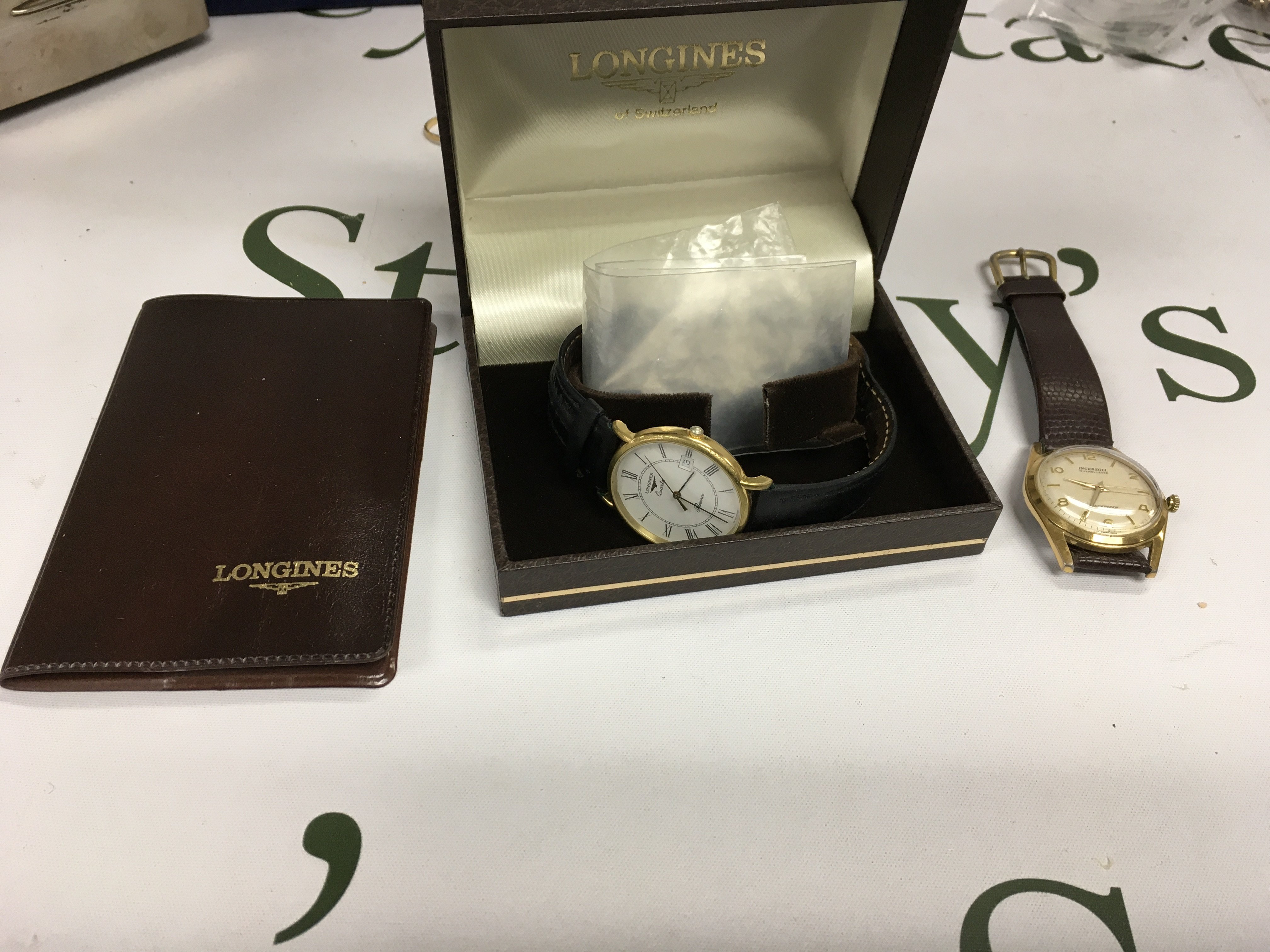 A modern gents longines watch with a gents ingersoll.