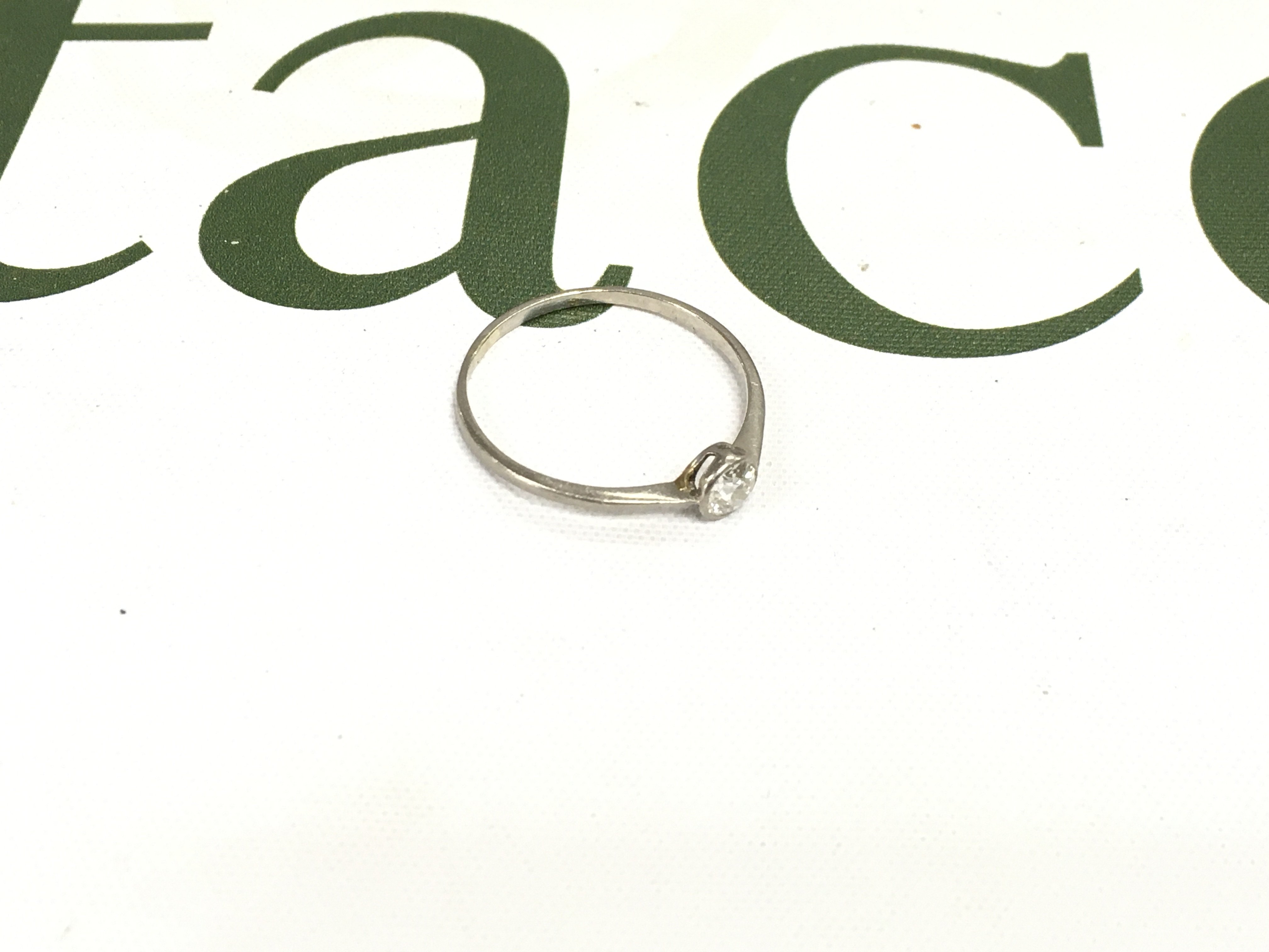 An unmarked diamond solitaire ring, approx weight 1.47 grams. Size V 1/2.