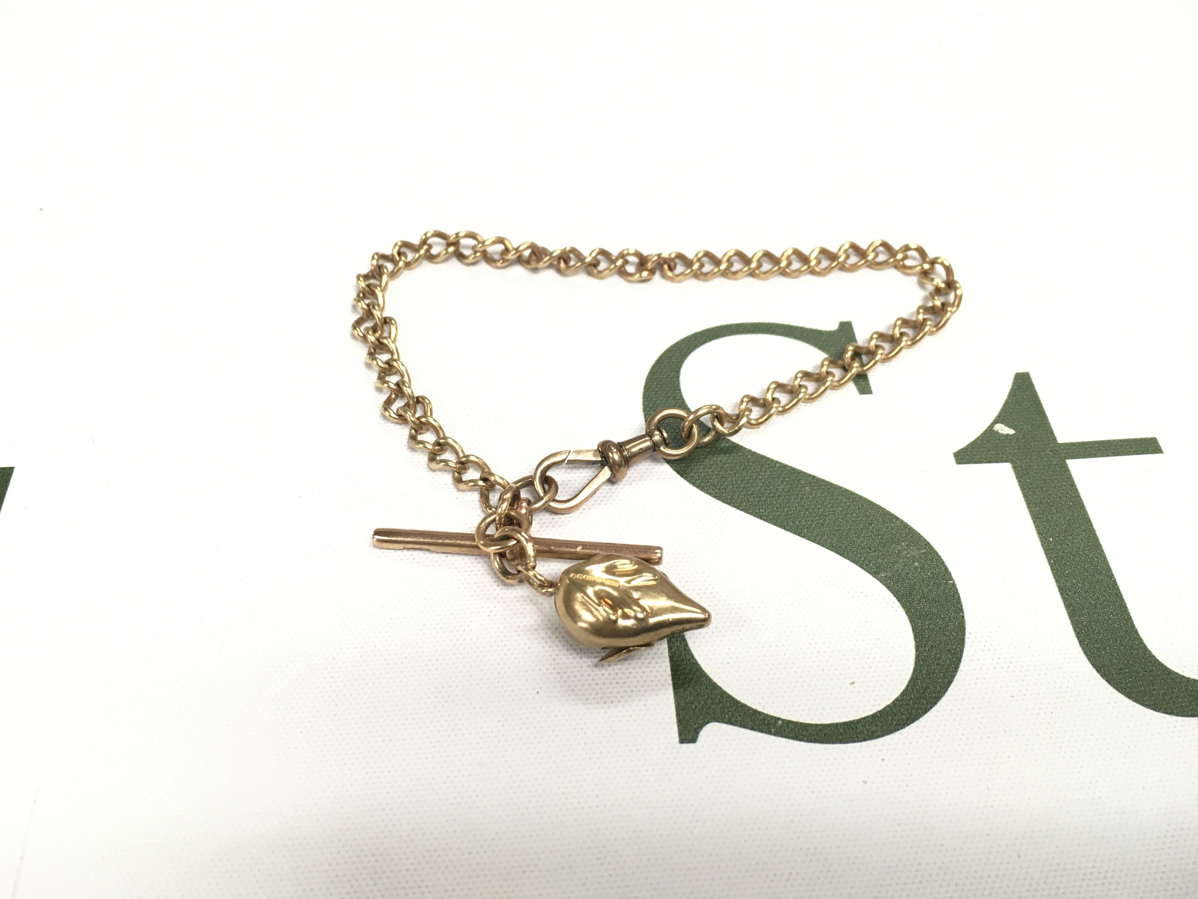 A 9ct gold half Albert chain with t bar and mouse pendant. Approx weight 15 grams.