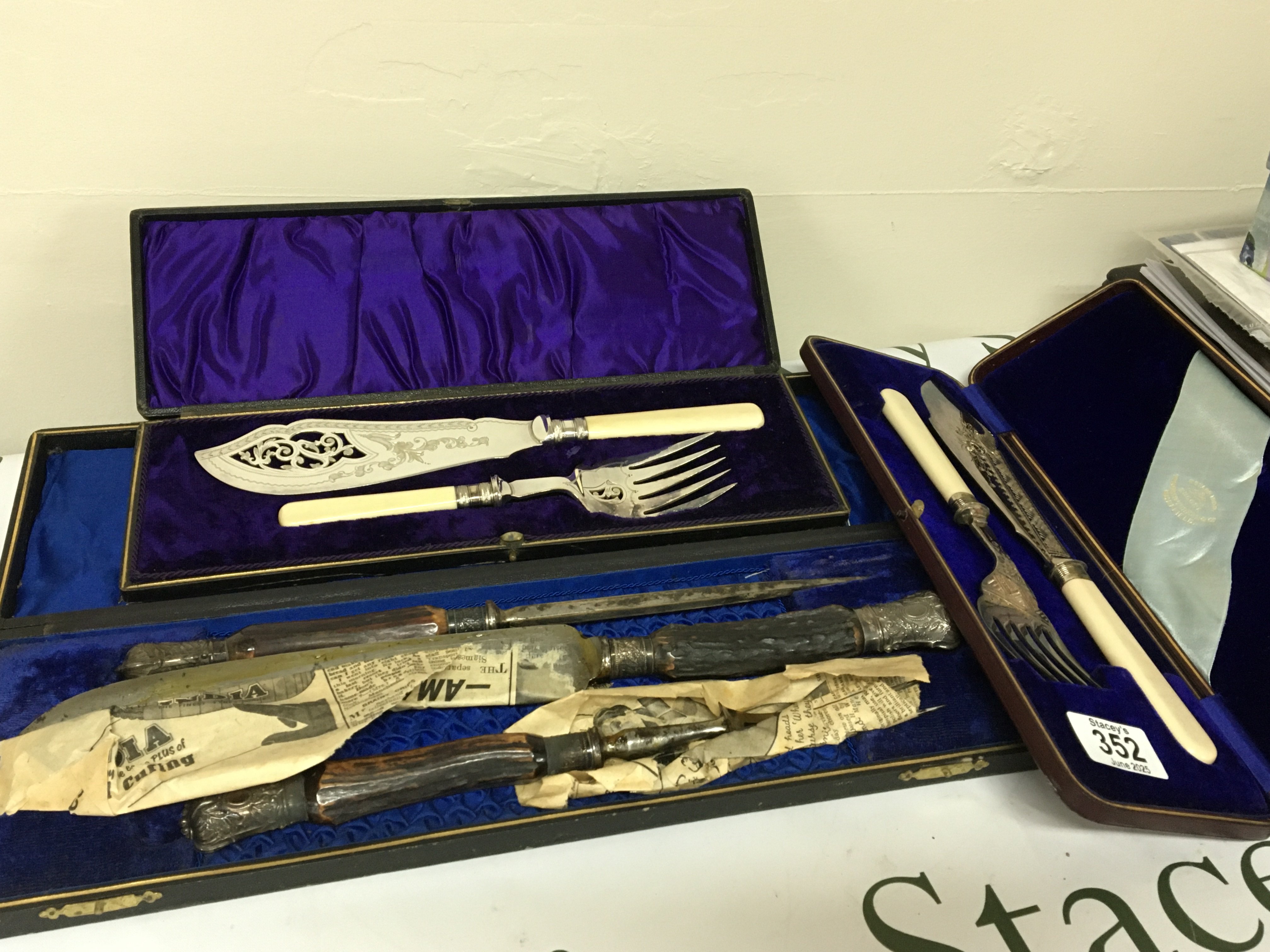Two cased silver plated fish slice and serving folk sets in a fitted case and horn and silver mounted carving sets. (3)
