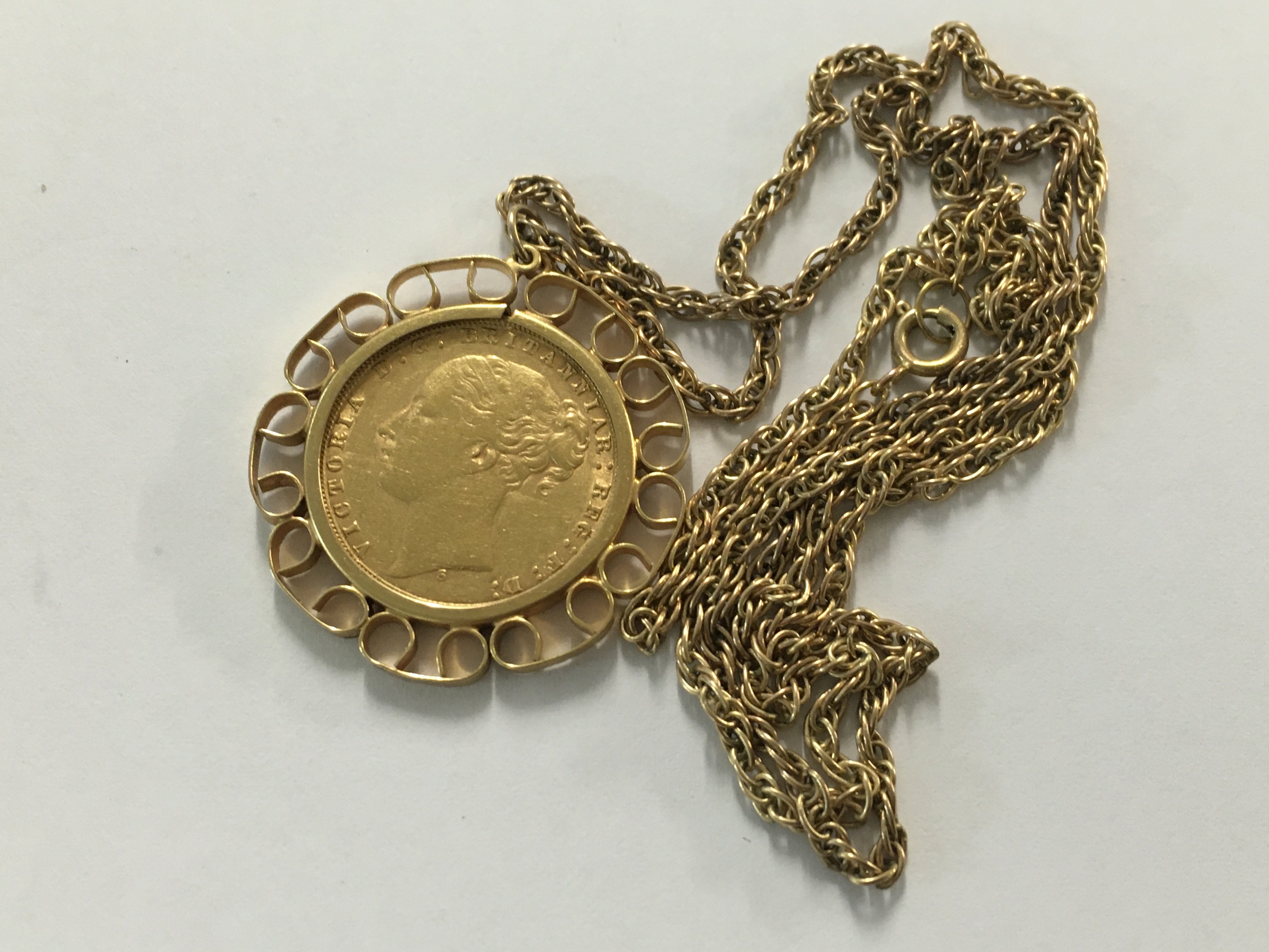 A Victorian gold sovereign fitted in a mount with a 9 ct gold chain. Total weight 17:21 grams.