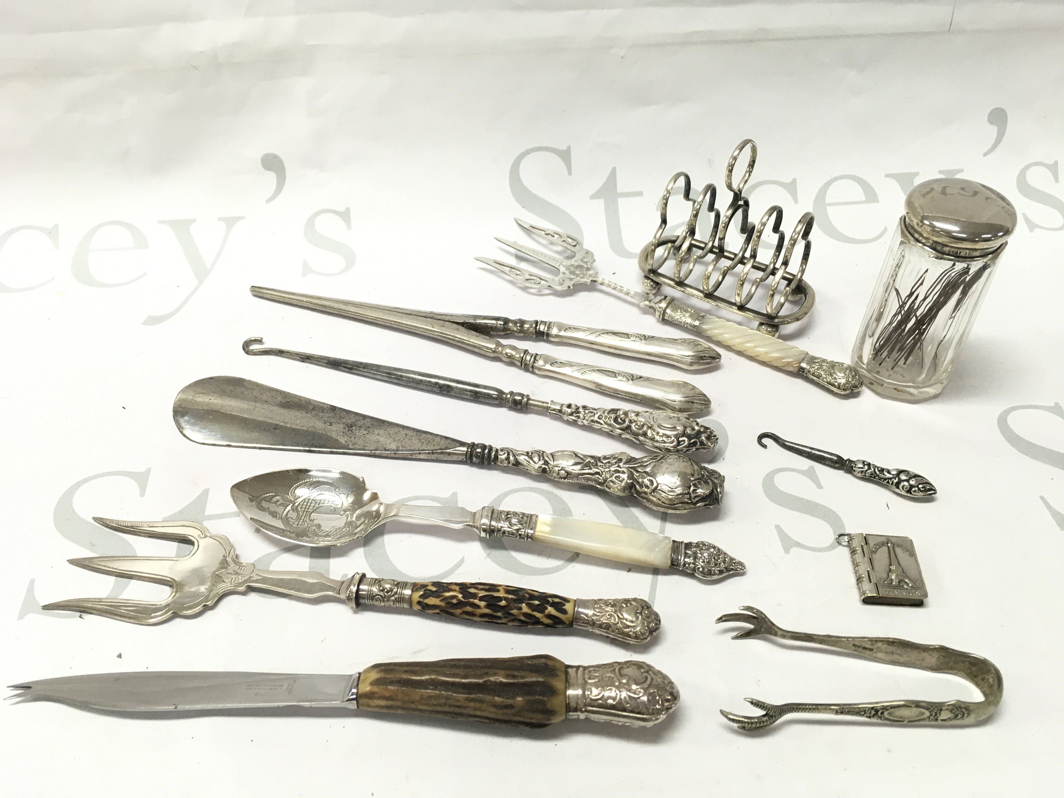 Silver hallmarked and silver plated items including toast rack, Paris book pendant, Glove stretcher, Crochet hook etc. postage category B