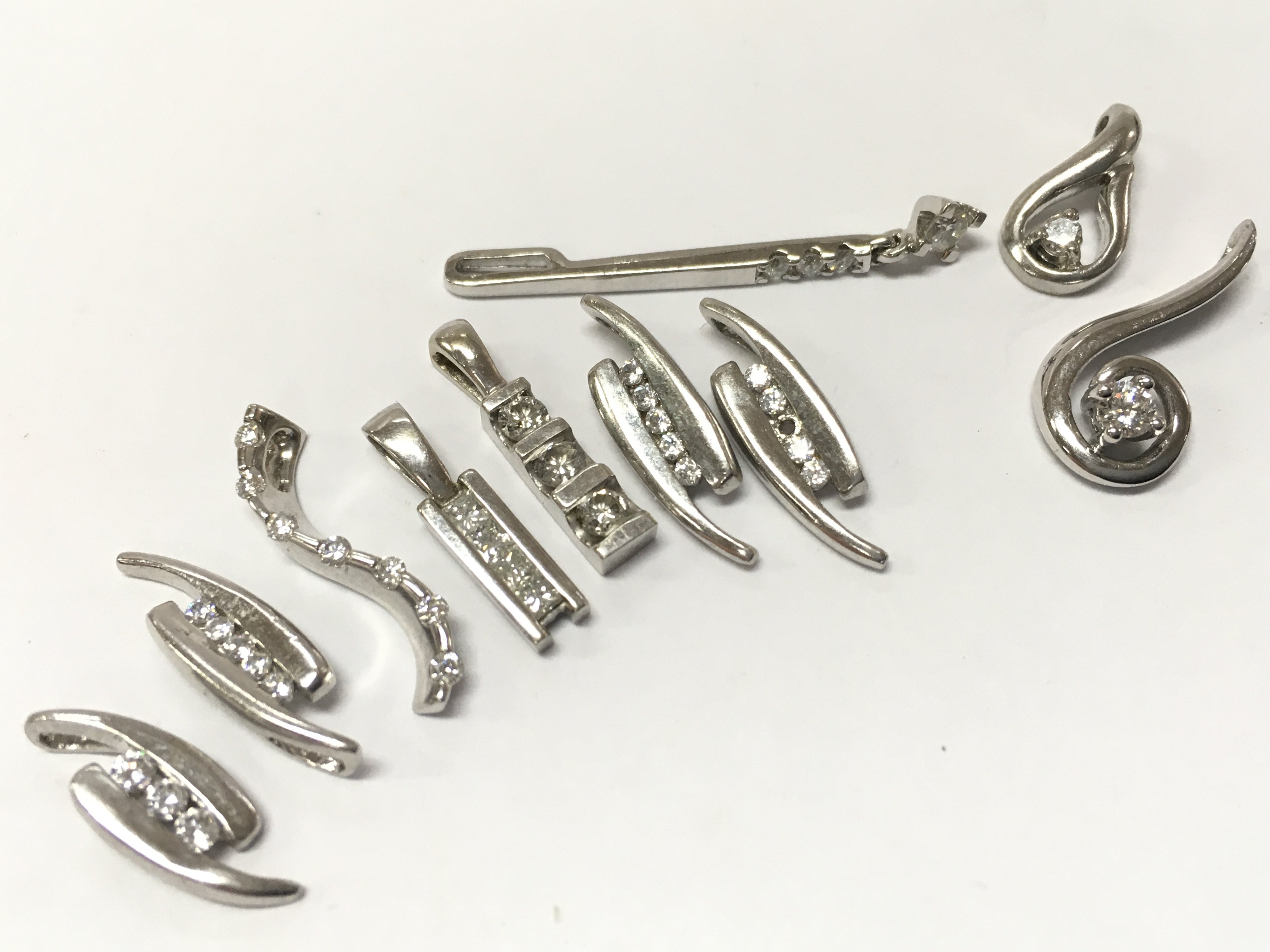9ct White gold assorted diamond pendants, 9g total weight, postage category A