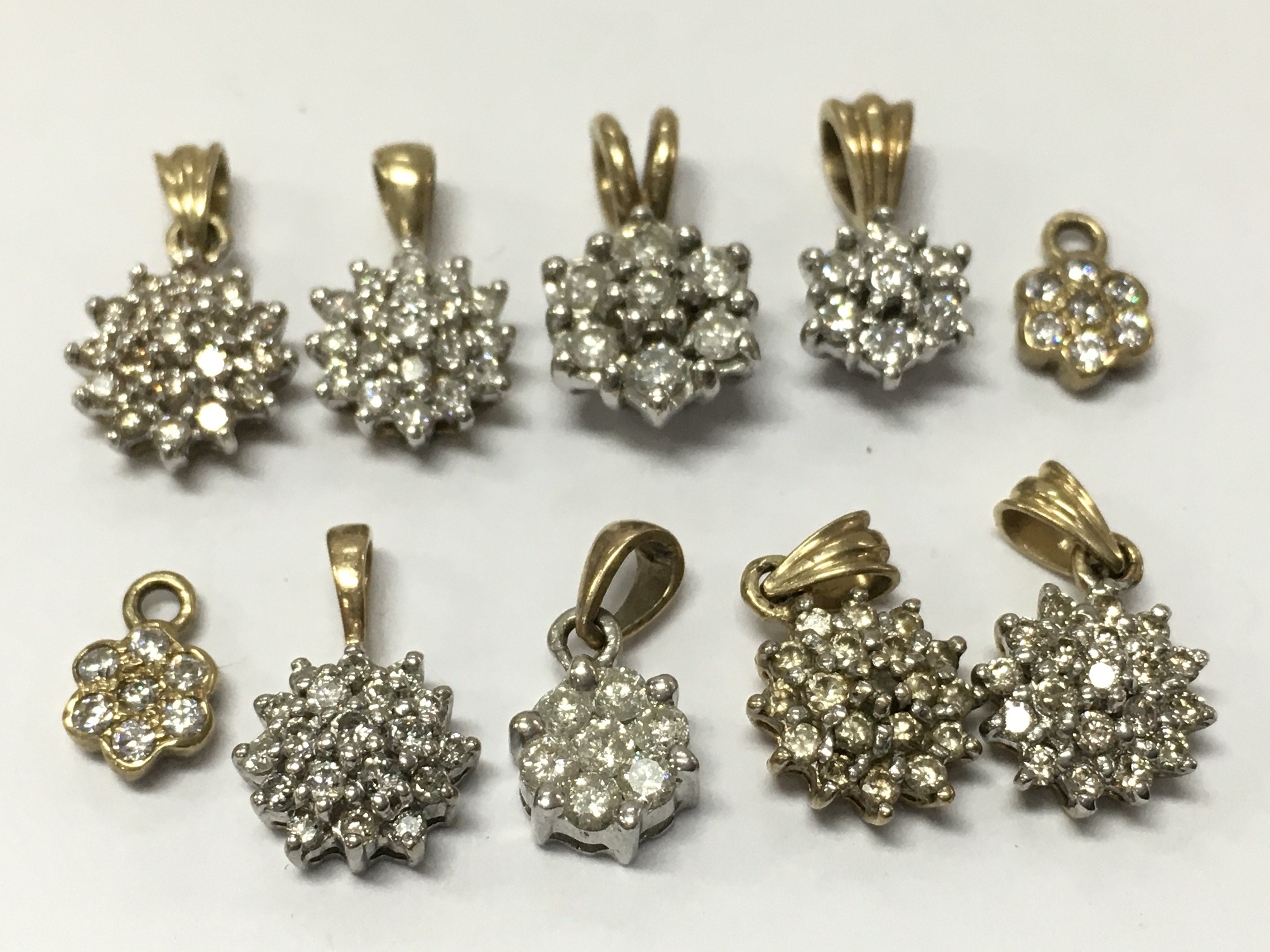 9ct Gold assorted diamond cluster pendants , 6.9g total weight. Postage category a