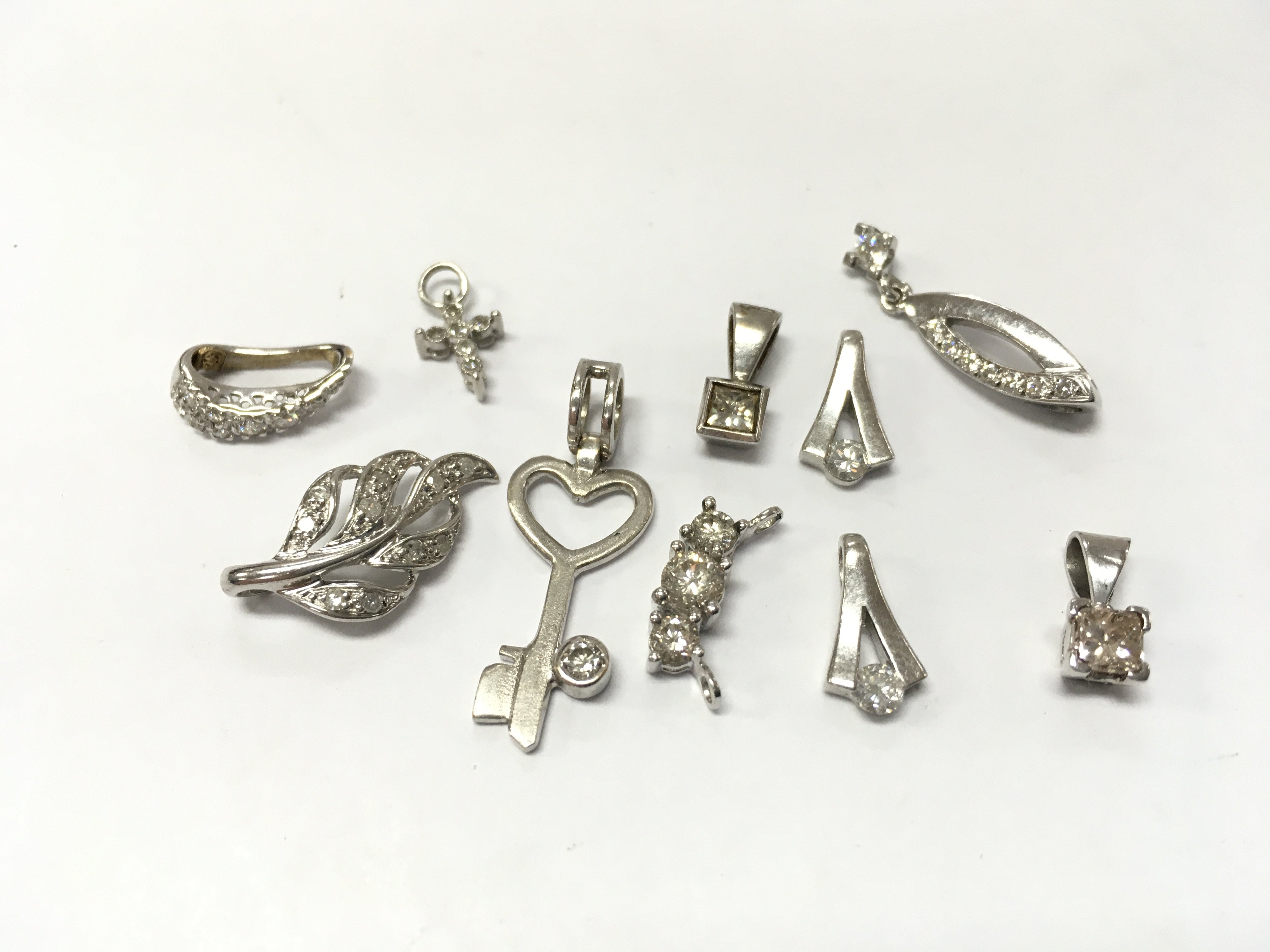 9ct white gold assorted diamond pendants , 8.7g total weight. Postage category A