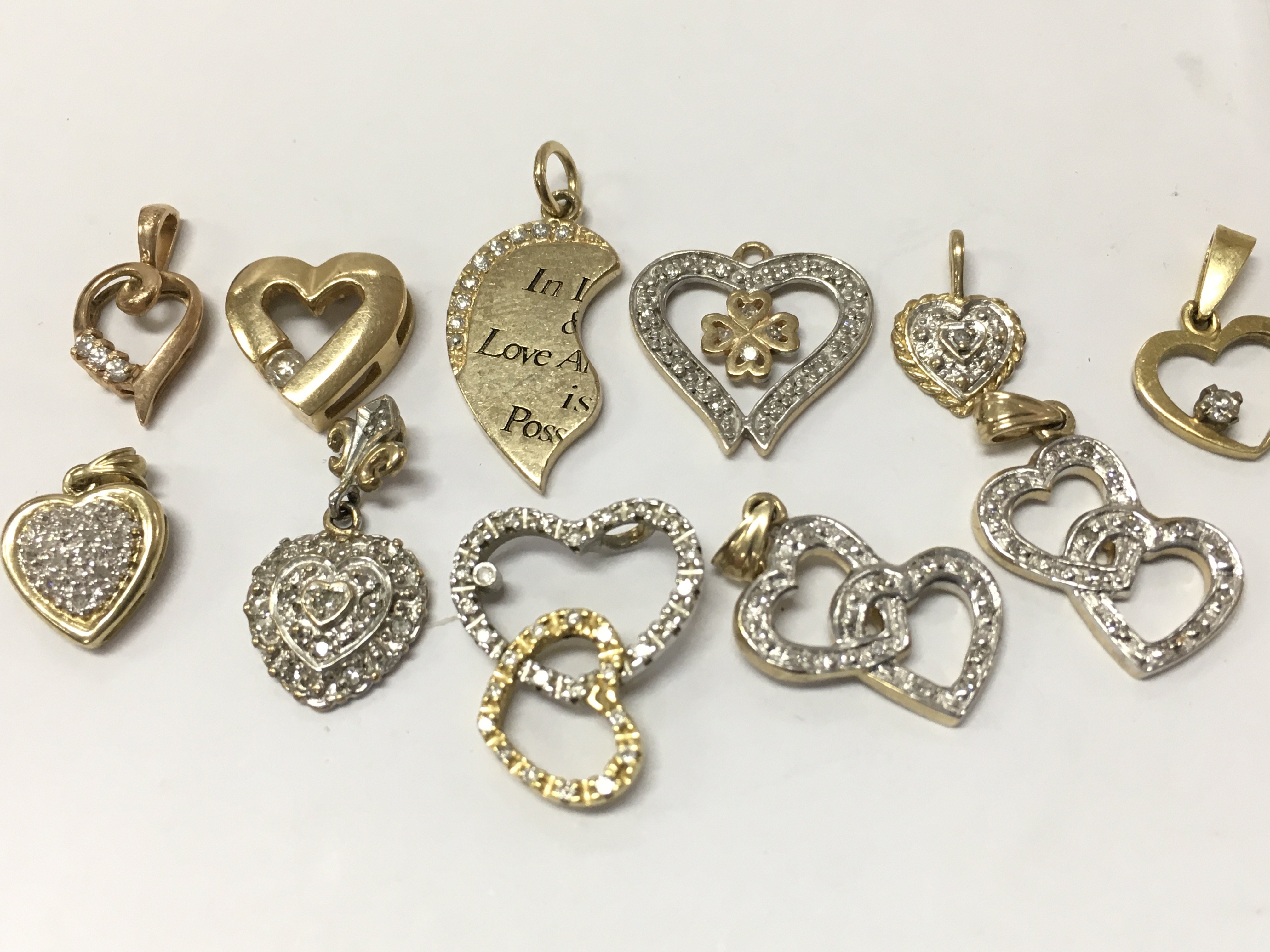9ct gold assorted diamond set heart pendants , 13g total weight. Postage category A