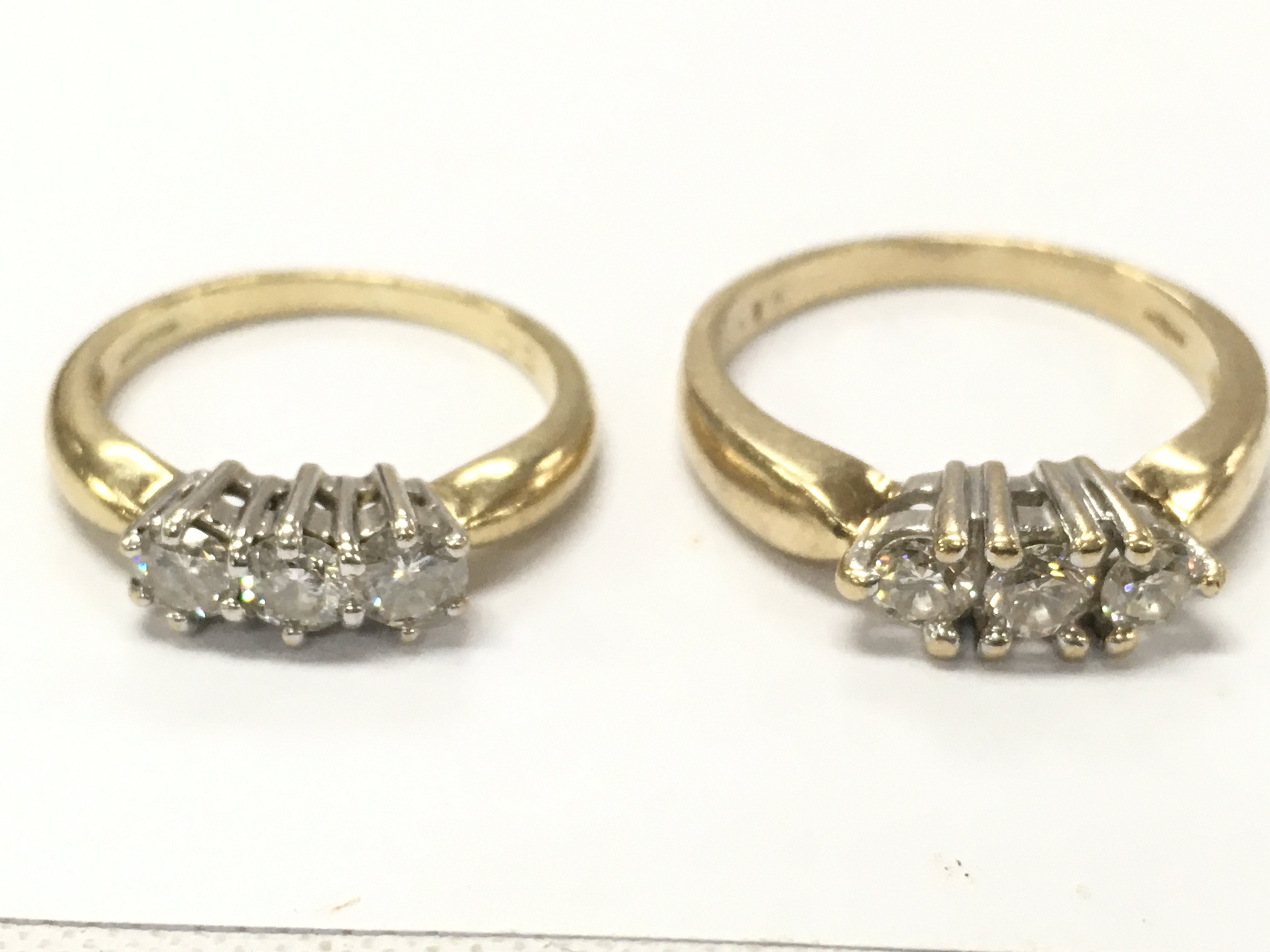 9ct gold diamond three stone rings, 5.6g total weight. Sizes J & O. Postage category A