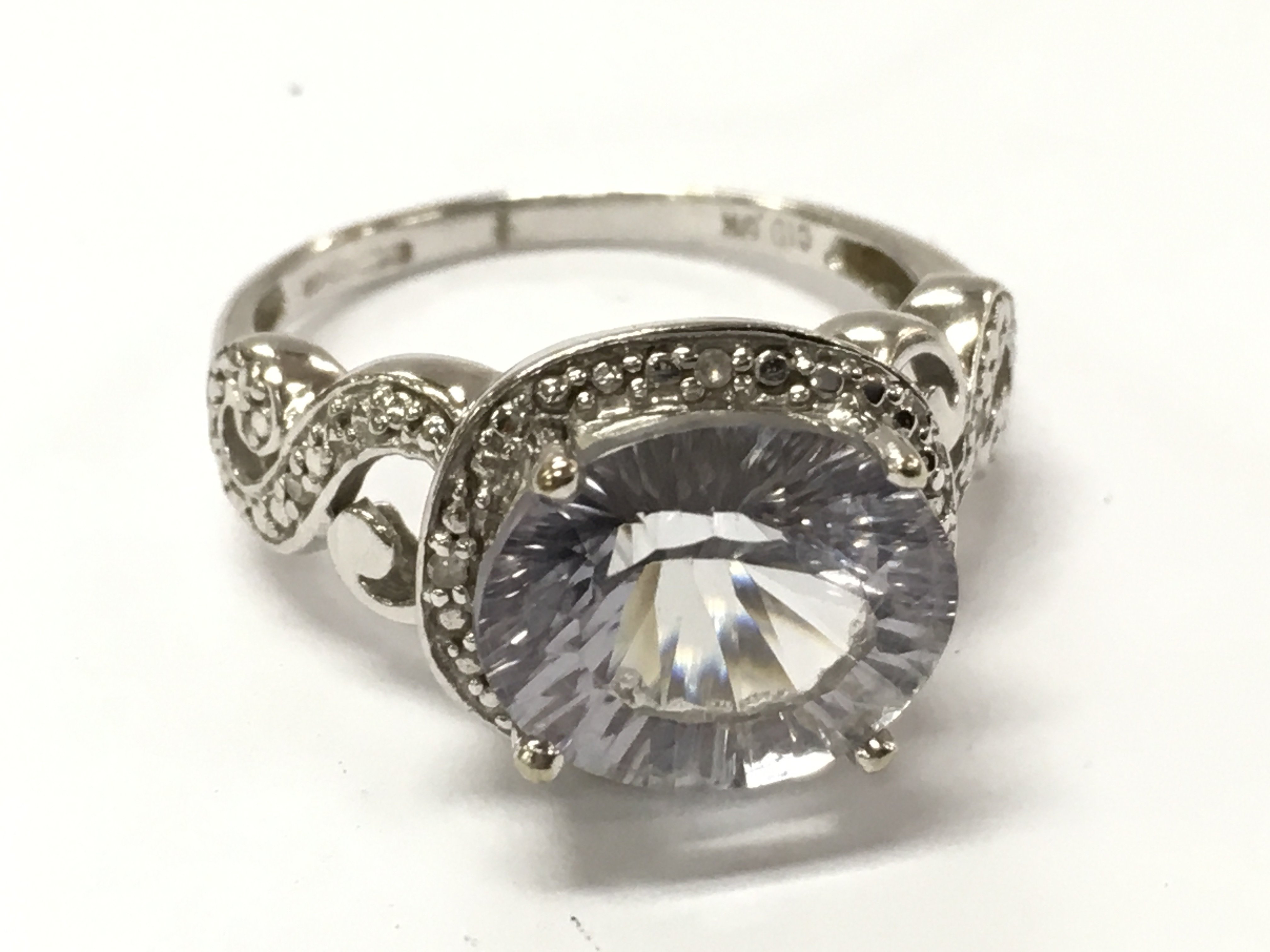 A 9ct white gold Lilac stone ring , size R , 5.2g total weight. Postage category A