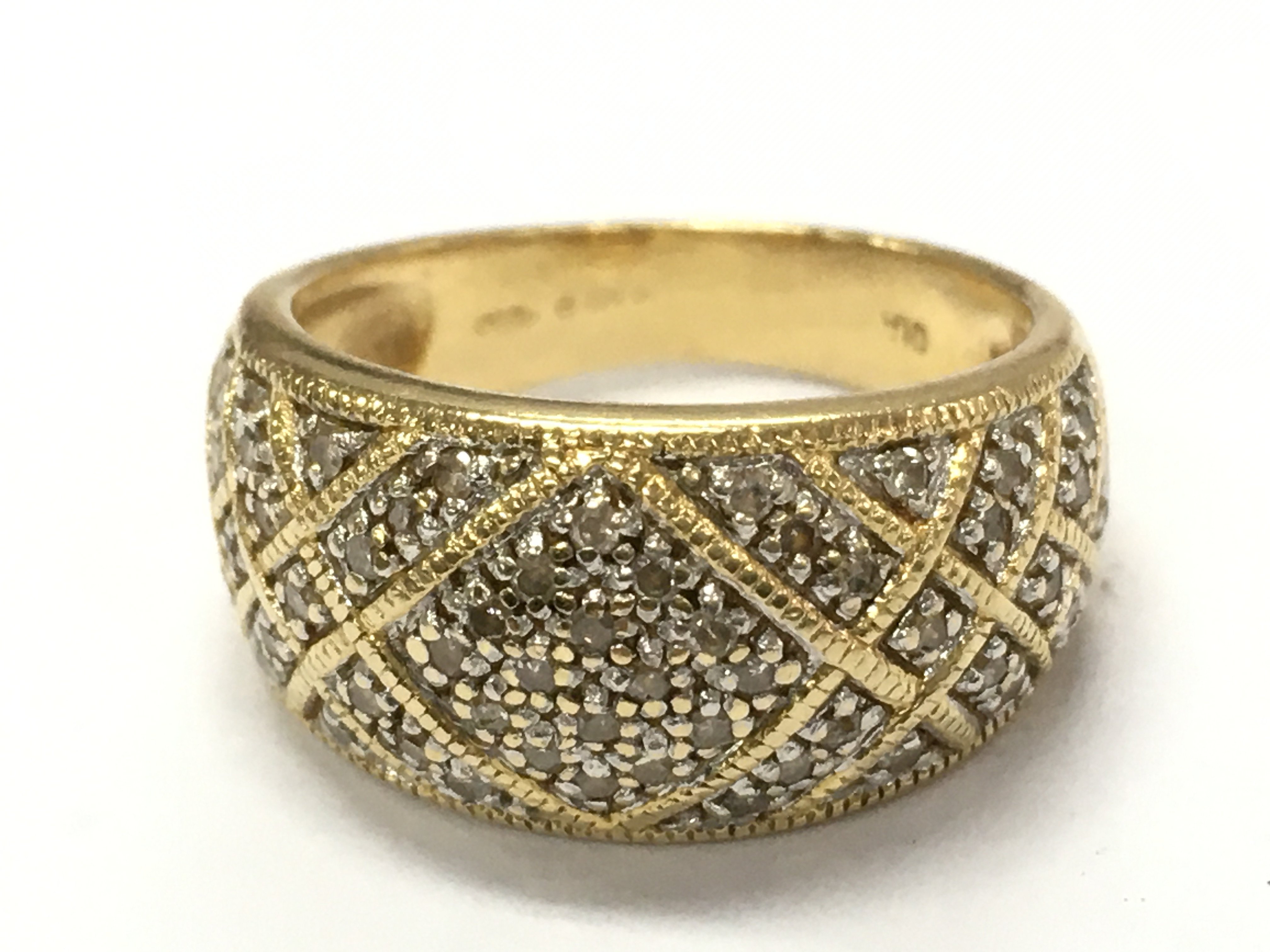An 18ct gold cluster band ring, 6.2g total weight. Postage category A