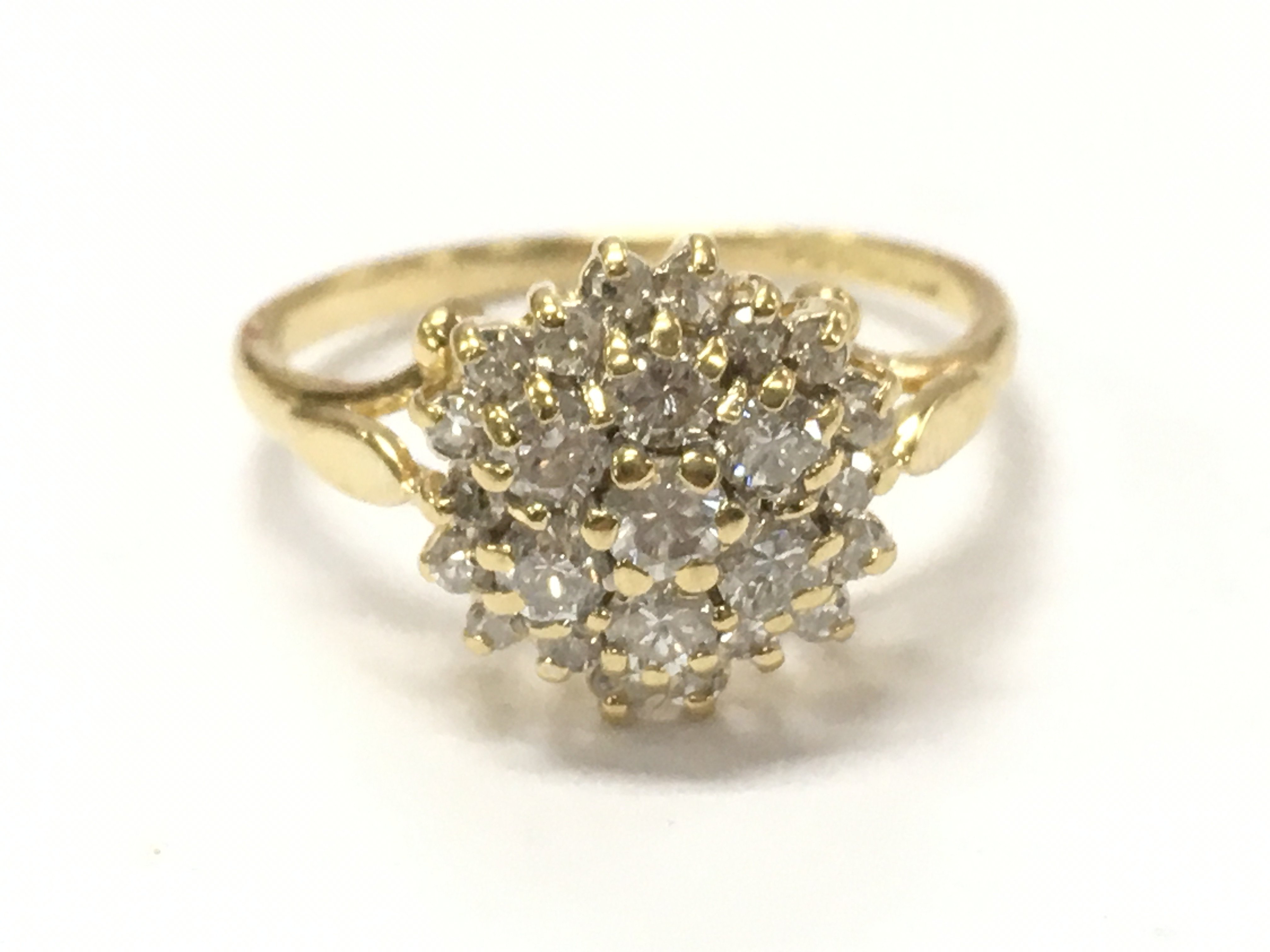 An 18ct gold diamond cluster ring, size I. 2.3G total weight. Postage category A