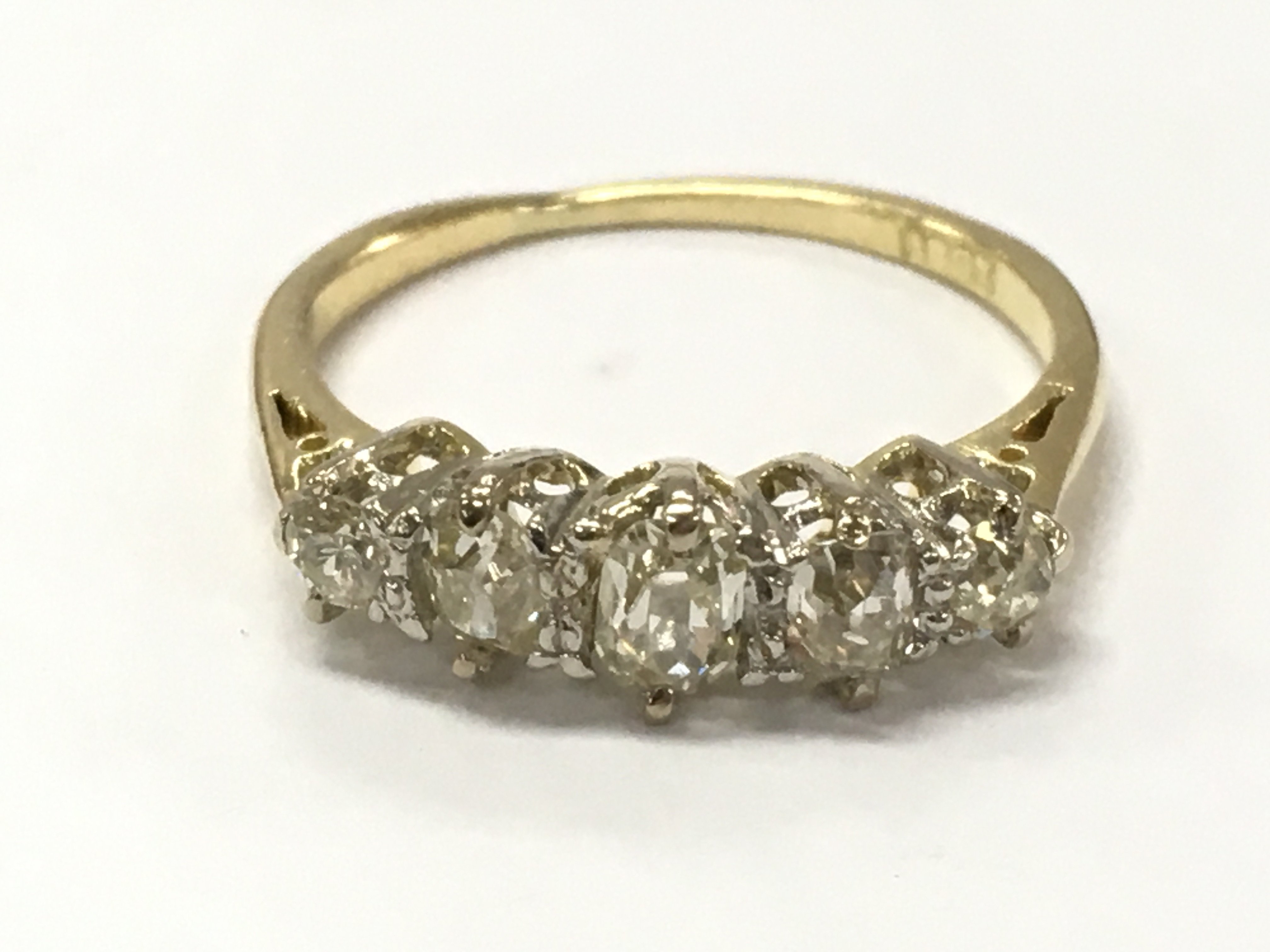 An 18ct gold 5 stone old cut diamond ring, size M. 2.6g total Weight . Postage category A