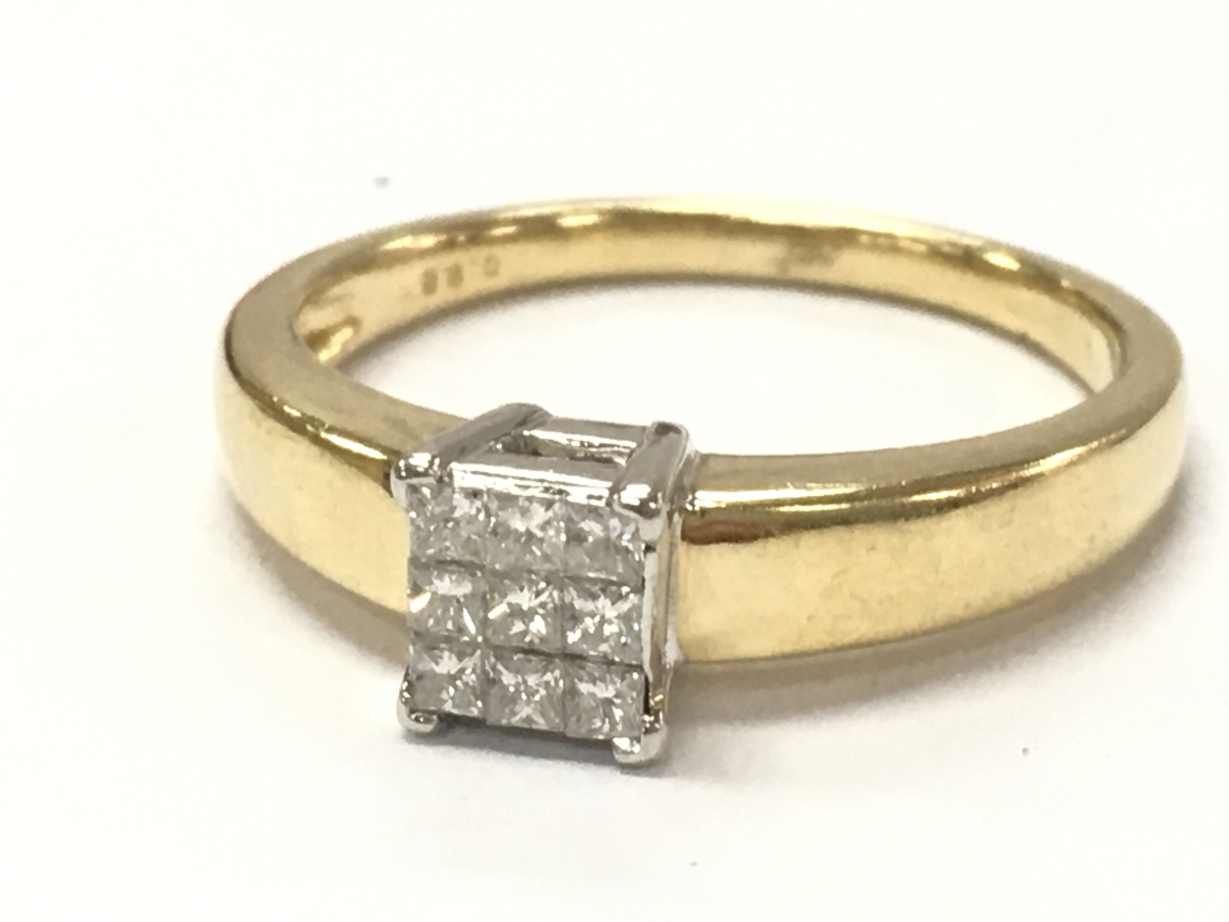 An 18ct gold 9x Princess cut diamond cluster ring, size Q .4.7g total weight. Postage category A