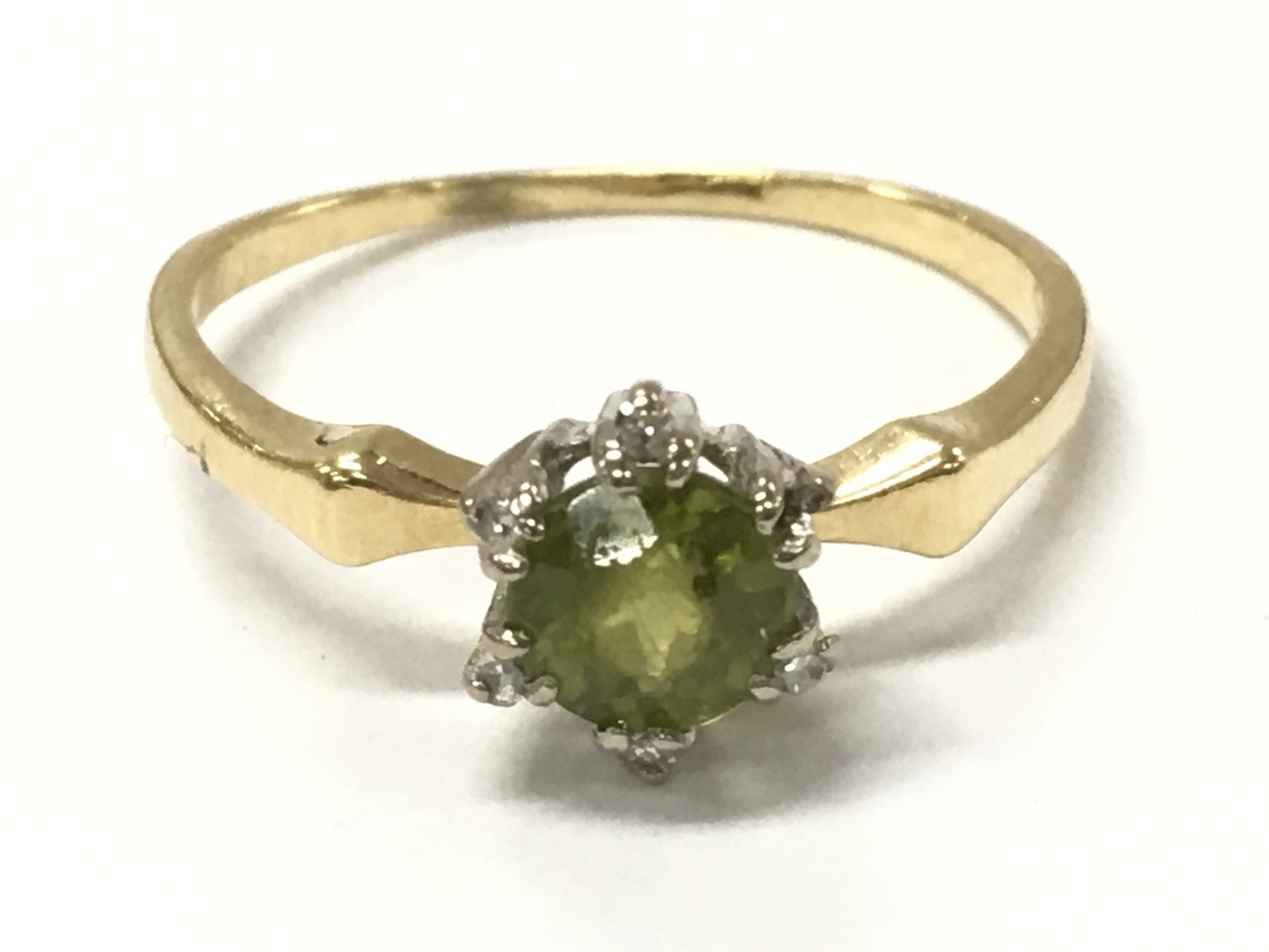 An 18ct gold peridot and diamond ring, size R, 2.8g postage category A
