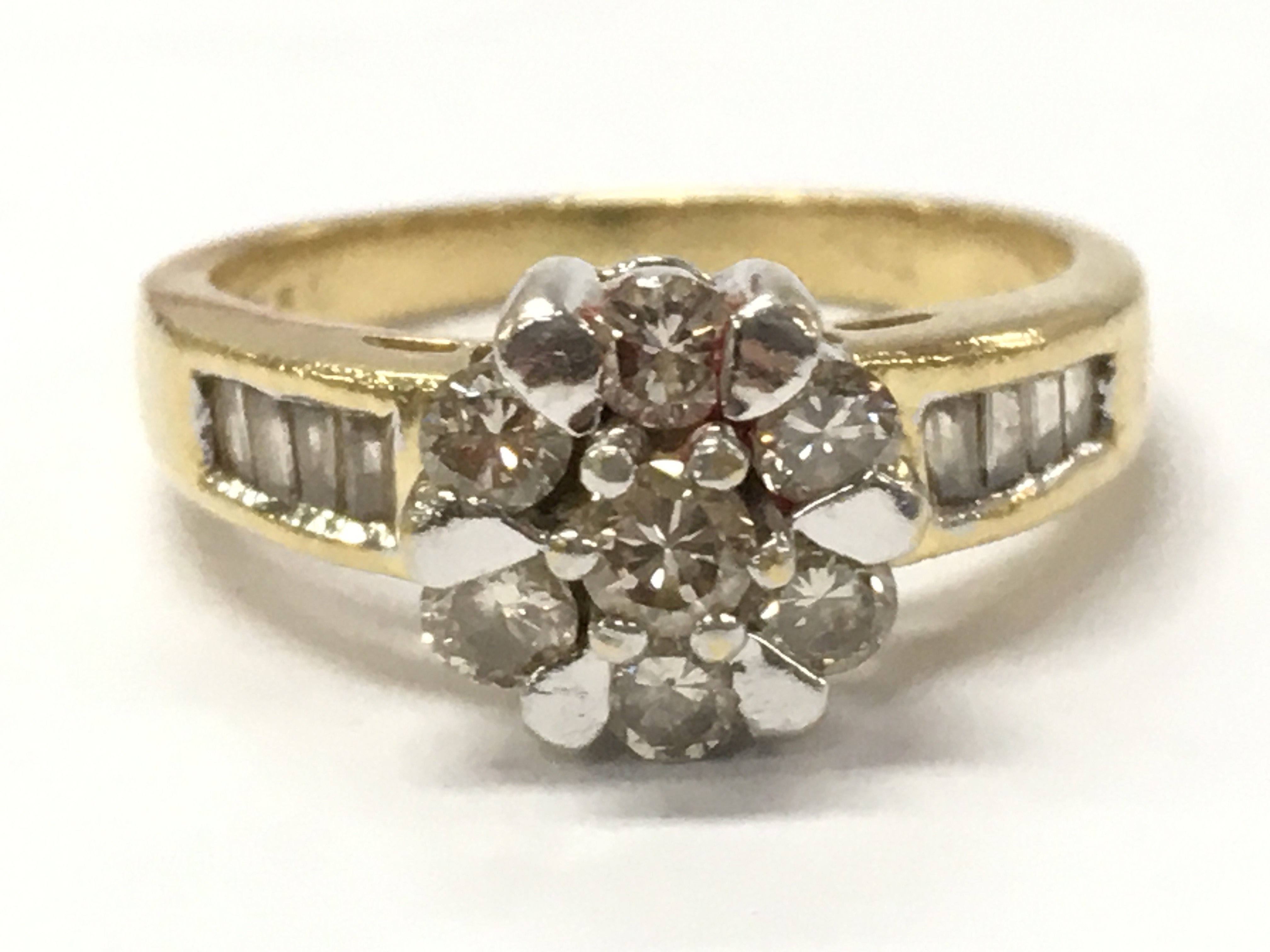 An 18ct gold diamond flower cluster ring 1/2ct size H 3.5g. Postage category A