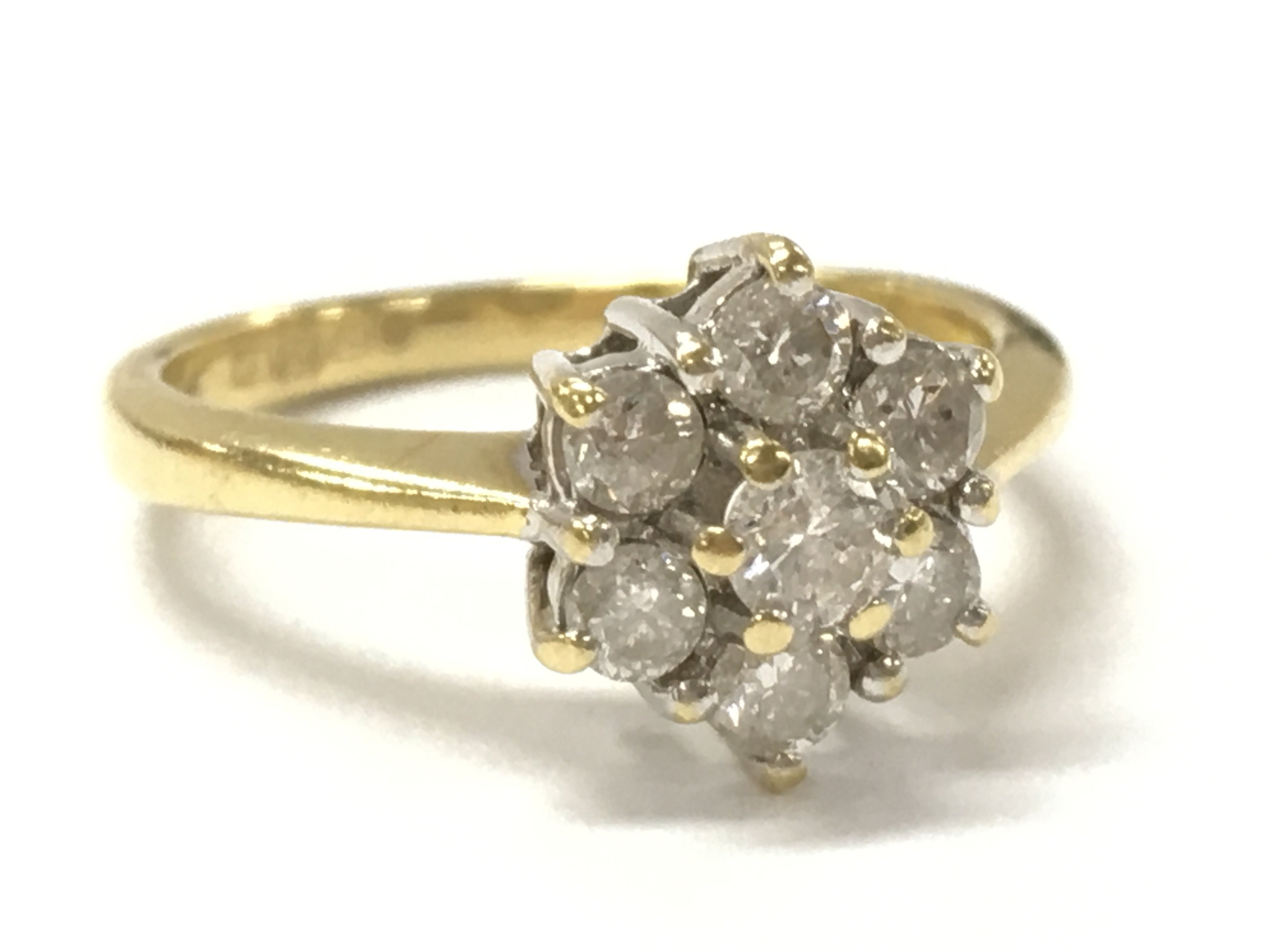 An 18ct gold diamond daisy cluster ring, 1/2ct, size J, 3.1g. Postage category A