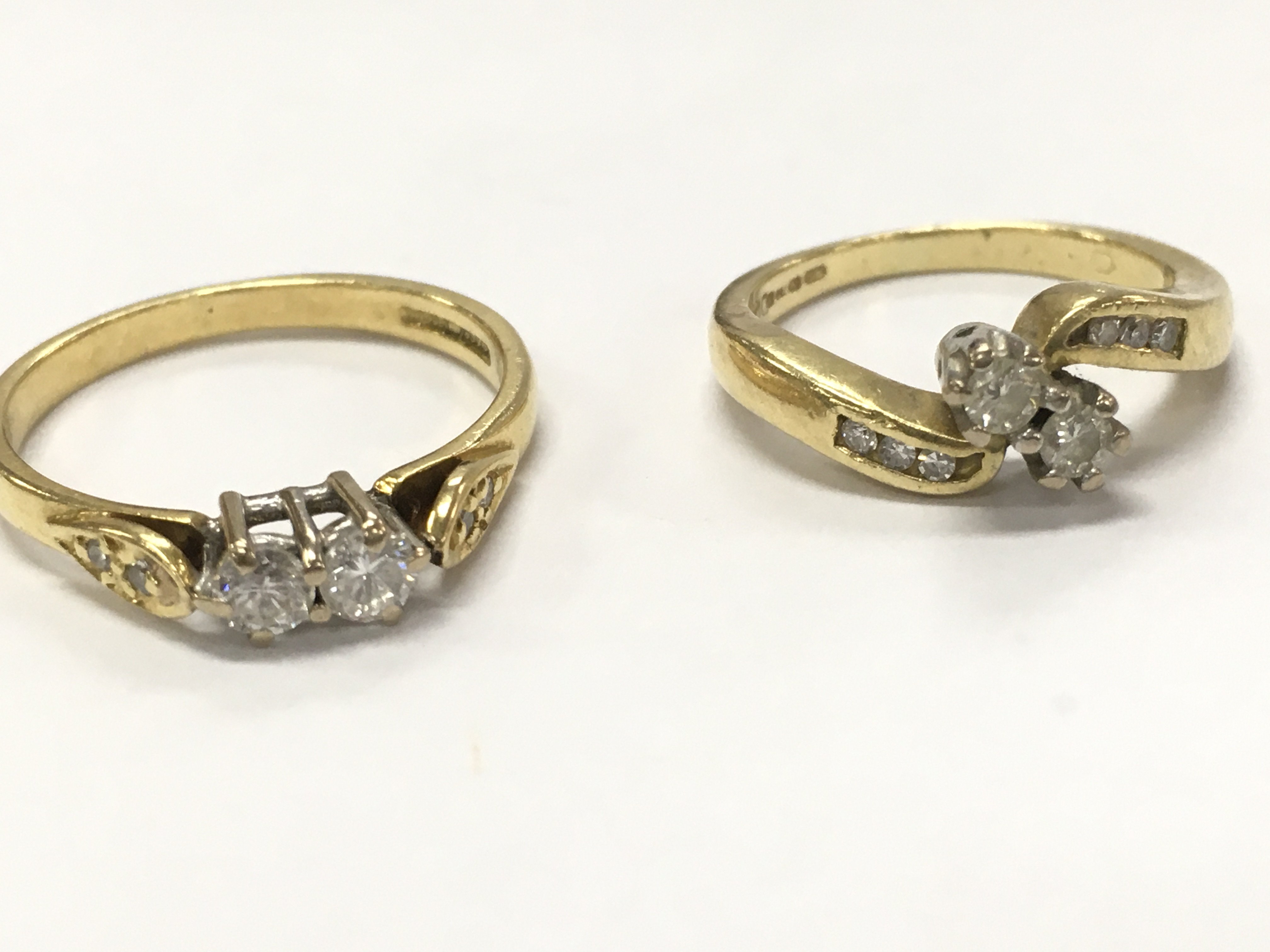 18ct gold 2 stone twist diamond rings size G, L/M. 5g total weight.Postage category A