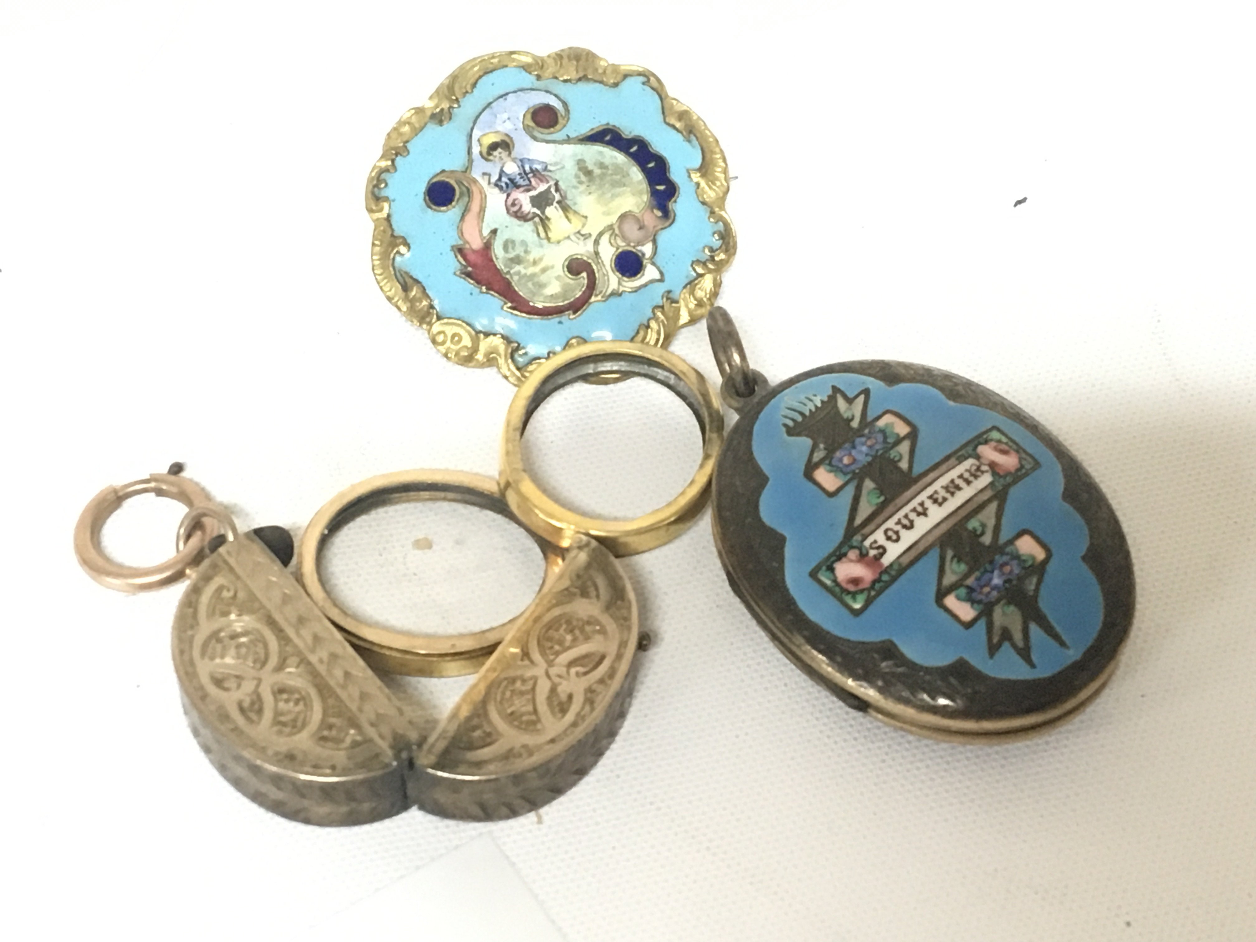 An enclosed locket with double oval portrait an enamel brooch made in Paris and a similar enclosed locket (3)