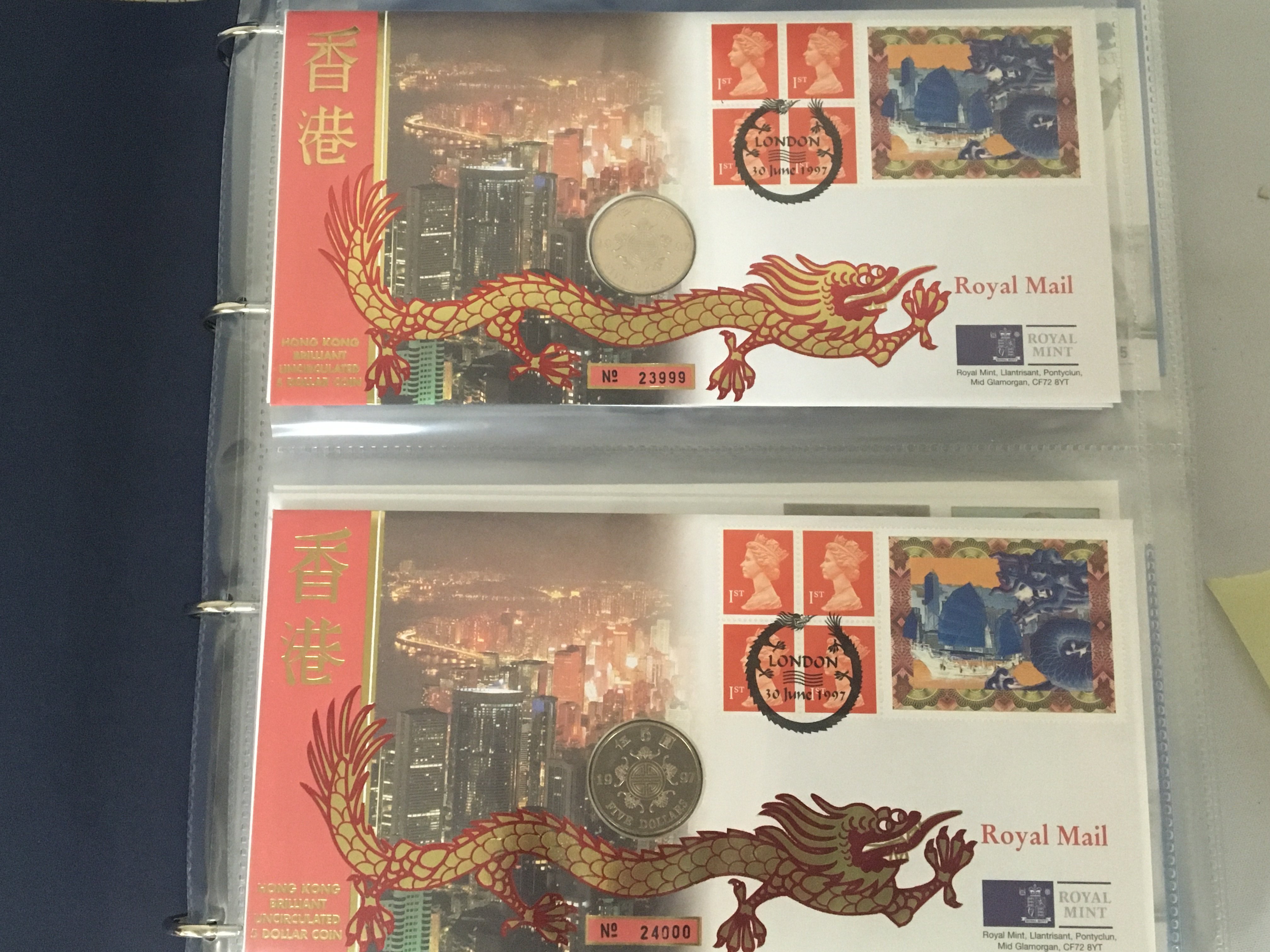 An Album containing a collection of Royal Mail Royal Mint Philatelic Numismatic Covers. in a blue album.