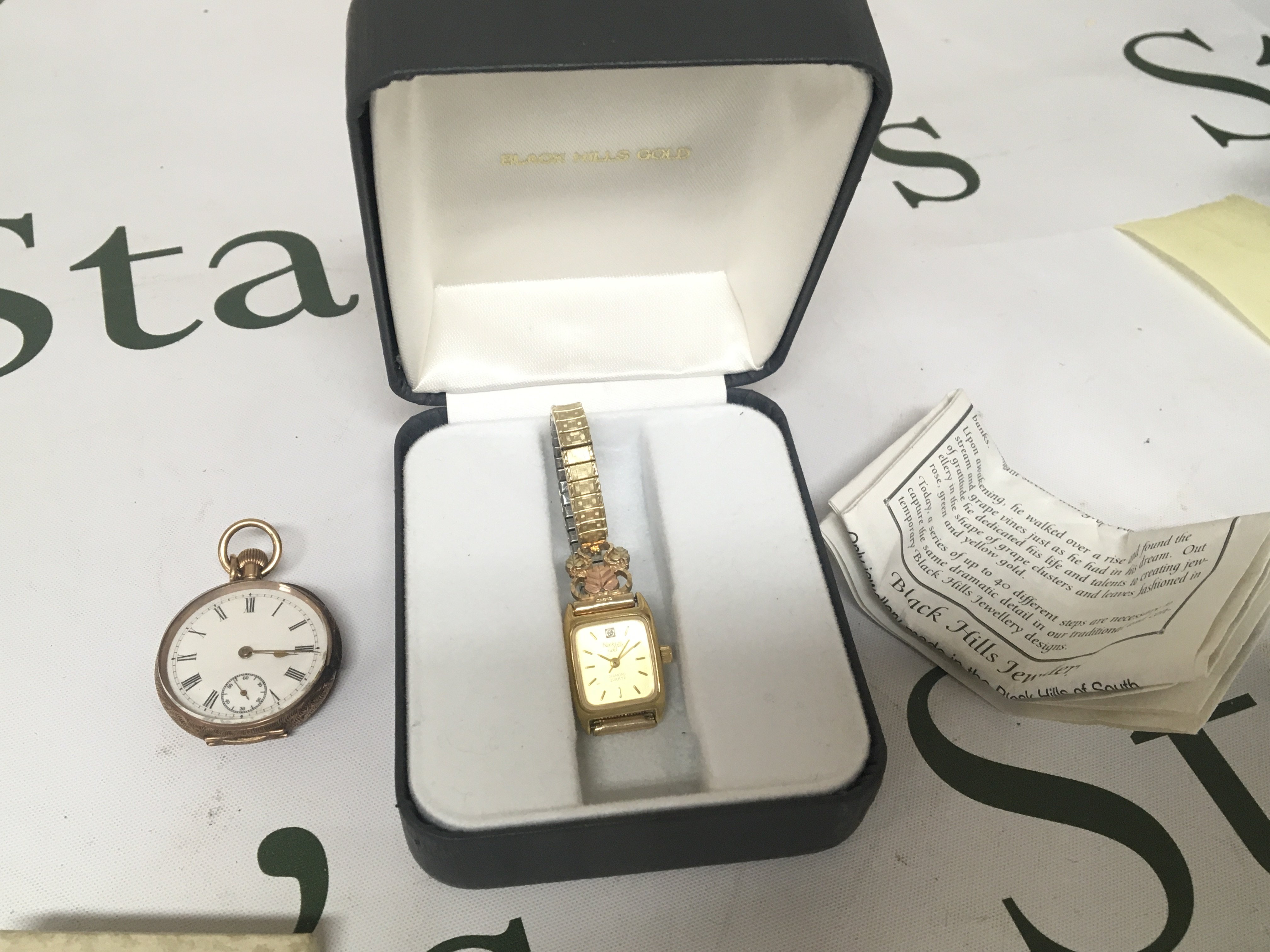 A 14carat gold cased ladies button wind watch for restoration and a Black Hills Jewellery ladies watch with box and paperwork. (2)