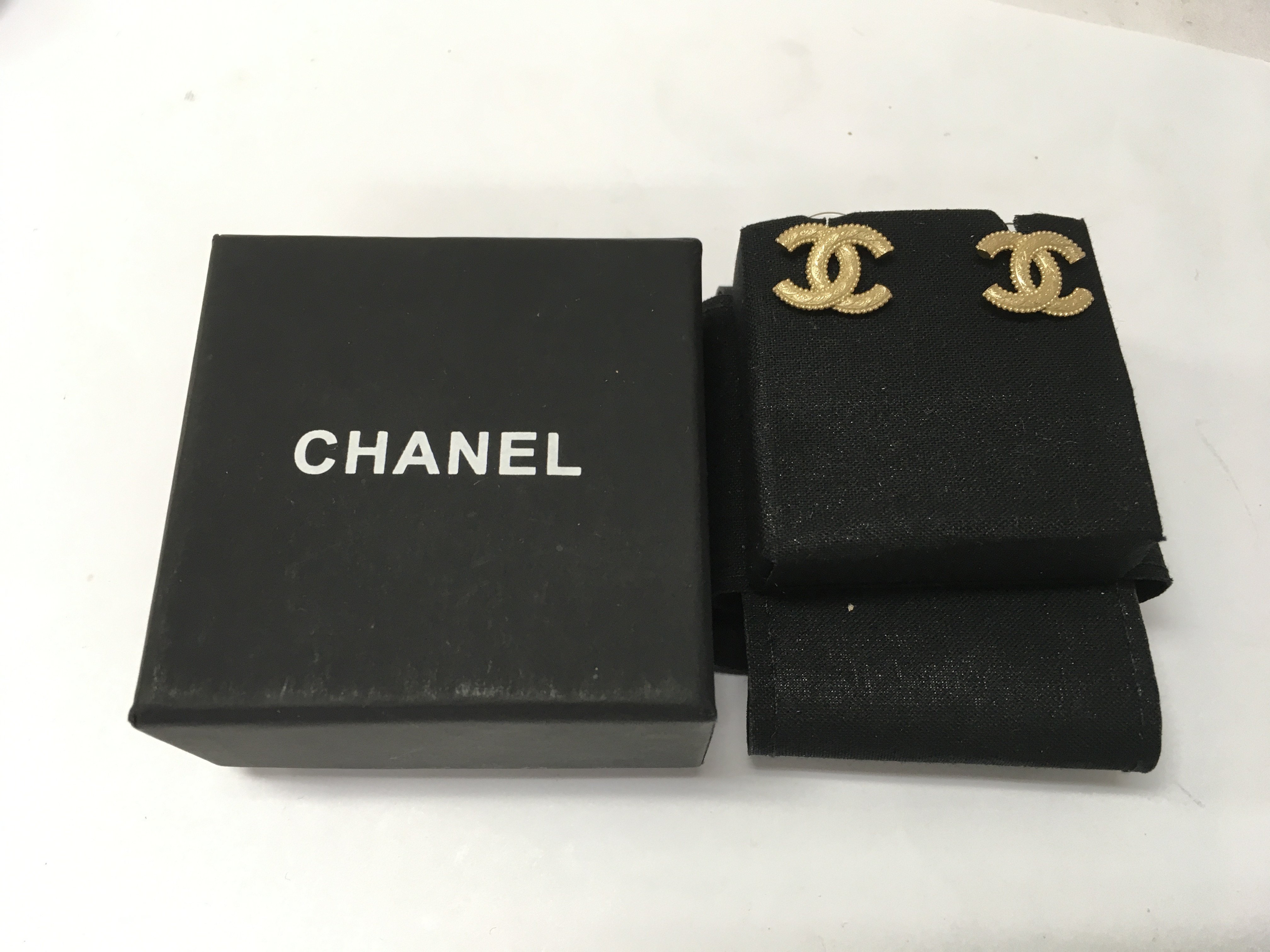 A pair of boxed channel earrings.