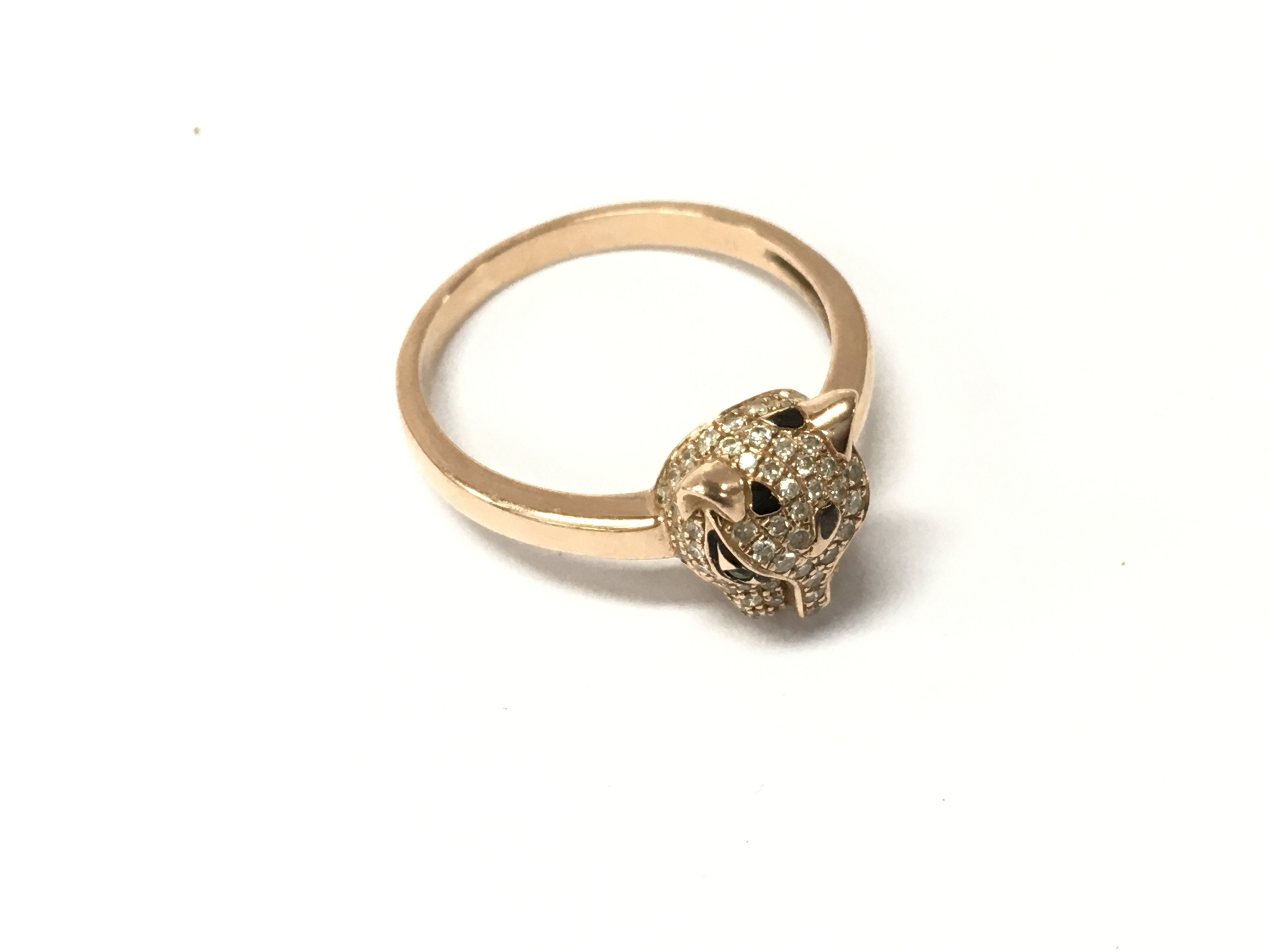A 14k stamped rose gold gold panther ring with a stone set head. Approx weight 2.85 grams. Size P.