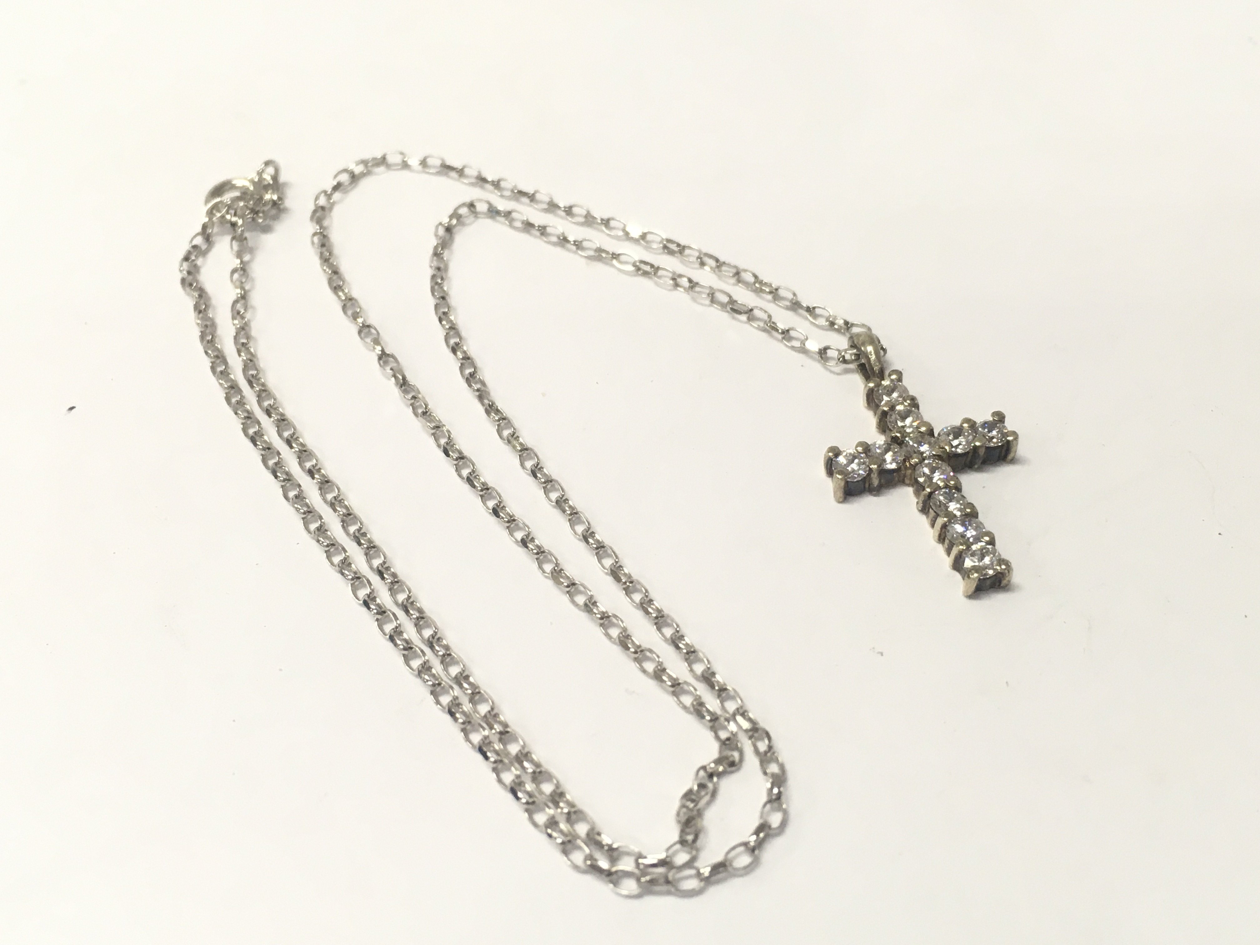 A 9ct white gold cross and 18inch white gold chain, Approx weight 5.6 grams.