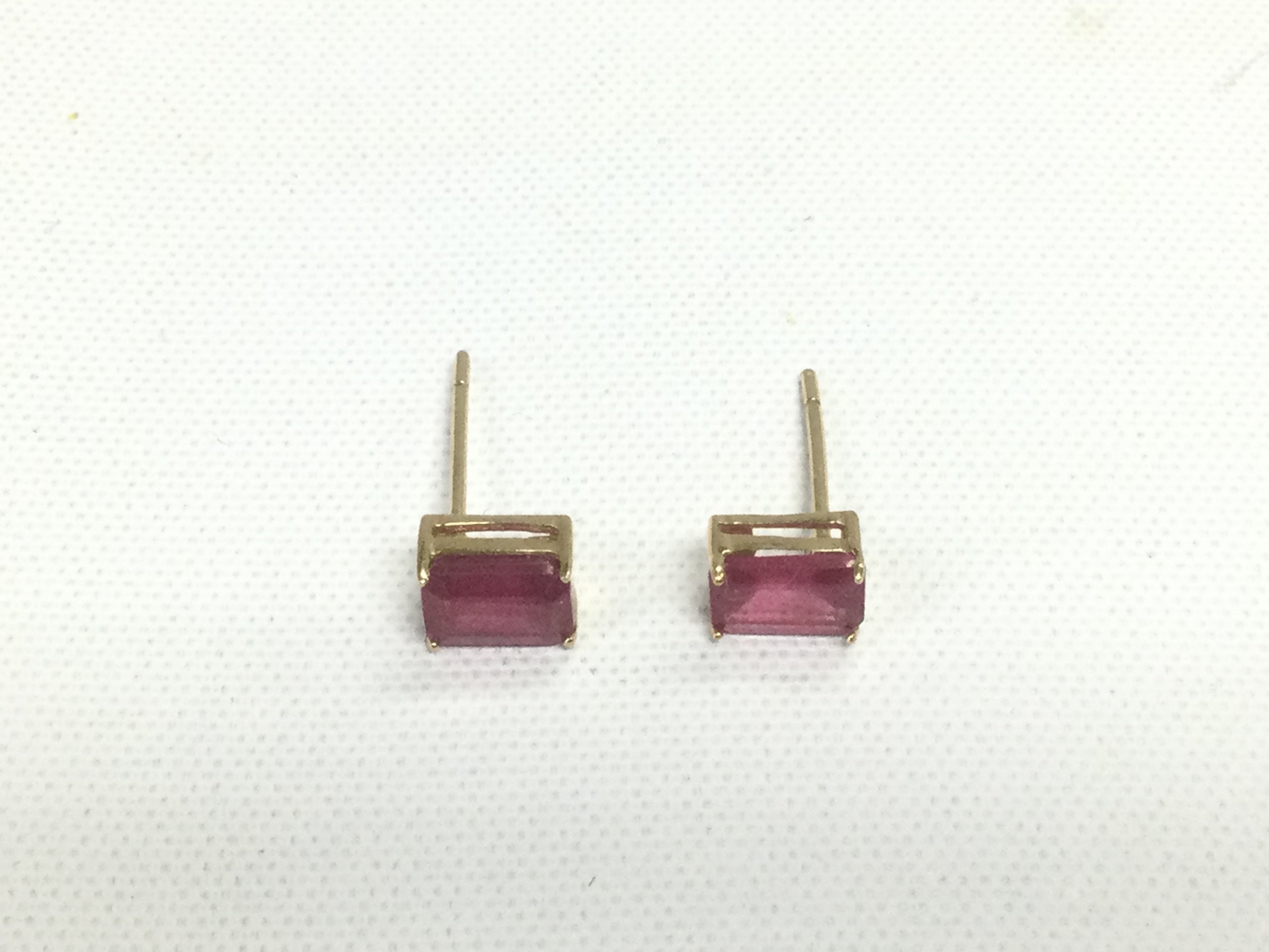 A pair of 9ct gold earrings set with rubies, approx 0.7g. Shipping category D.