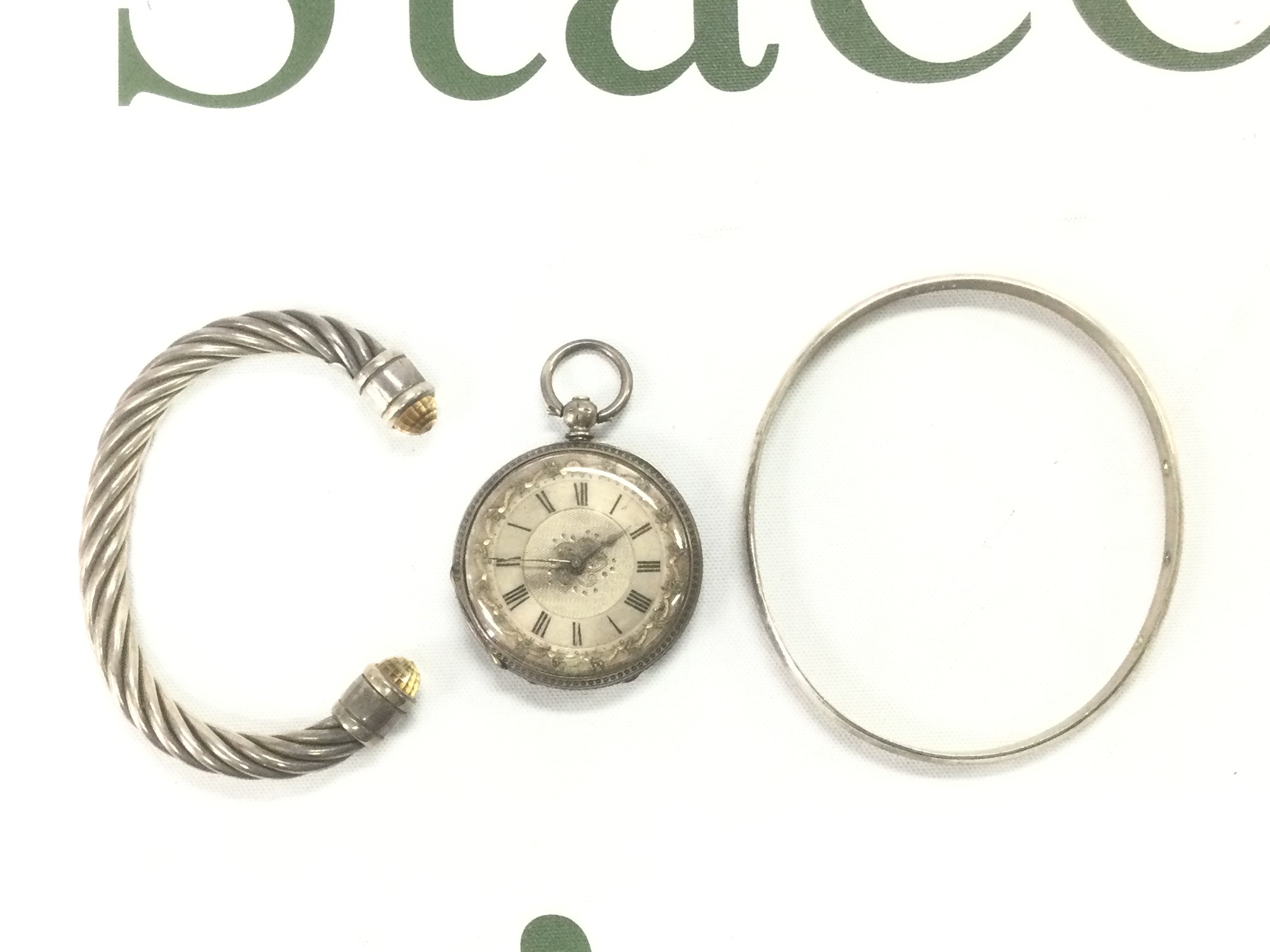 Two silver bangles and a silver pocket watch. Shipping category A.