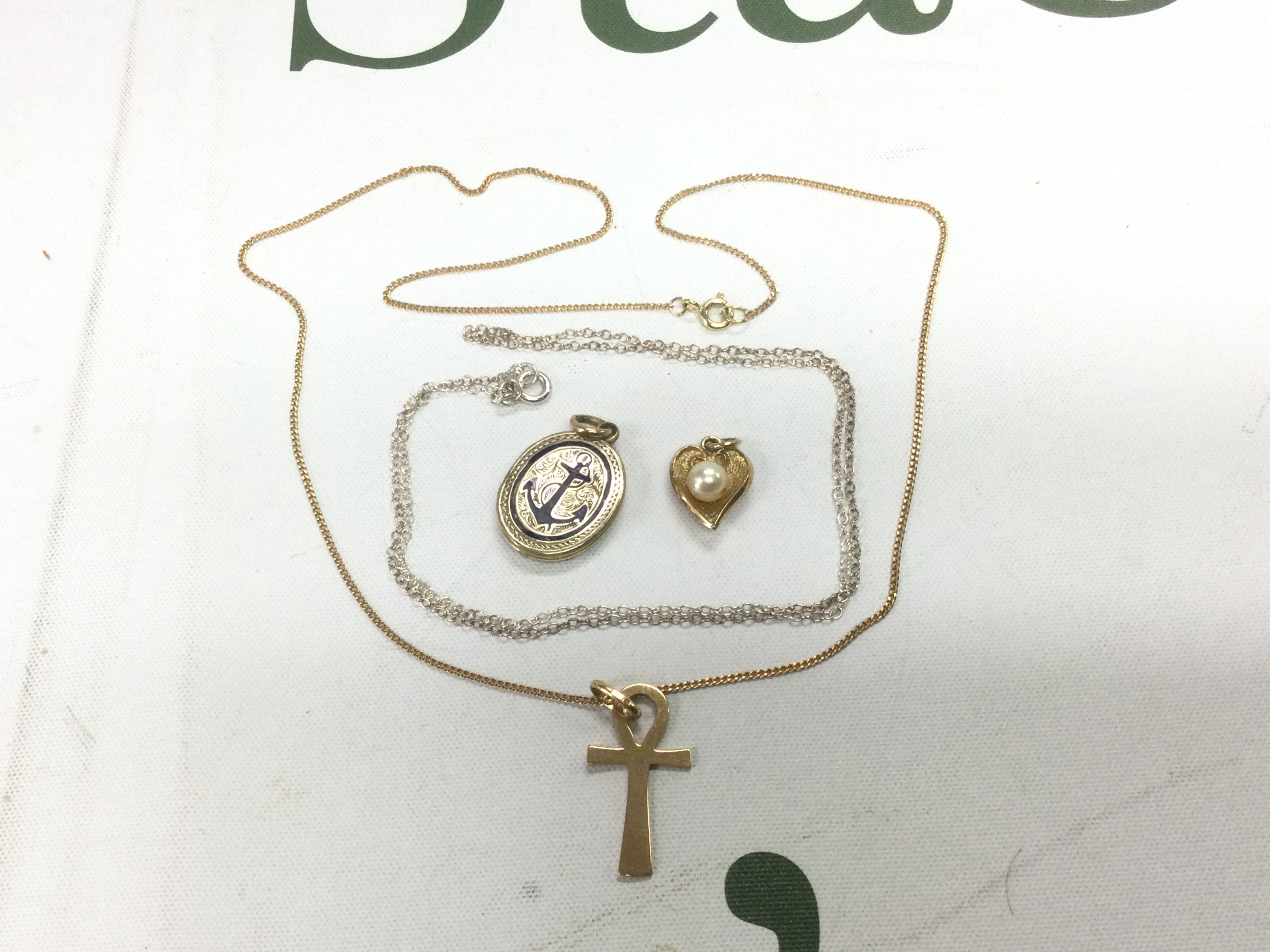 A small collection of pendants and chains including some gold examples. Shipping category A.