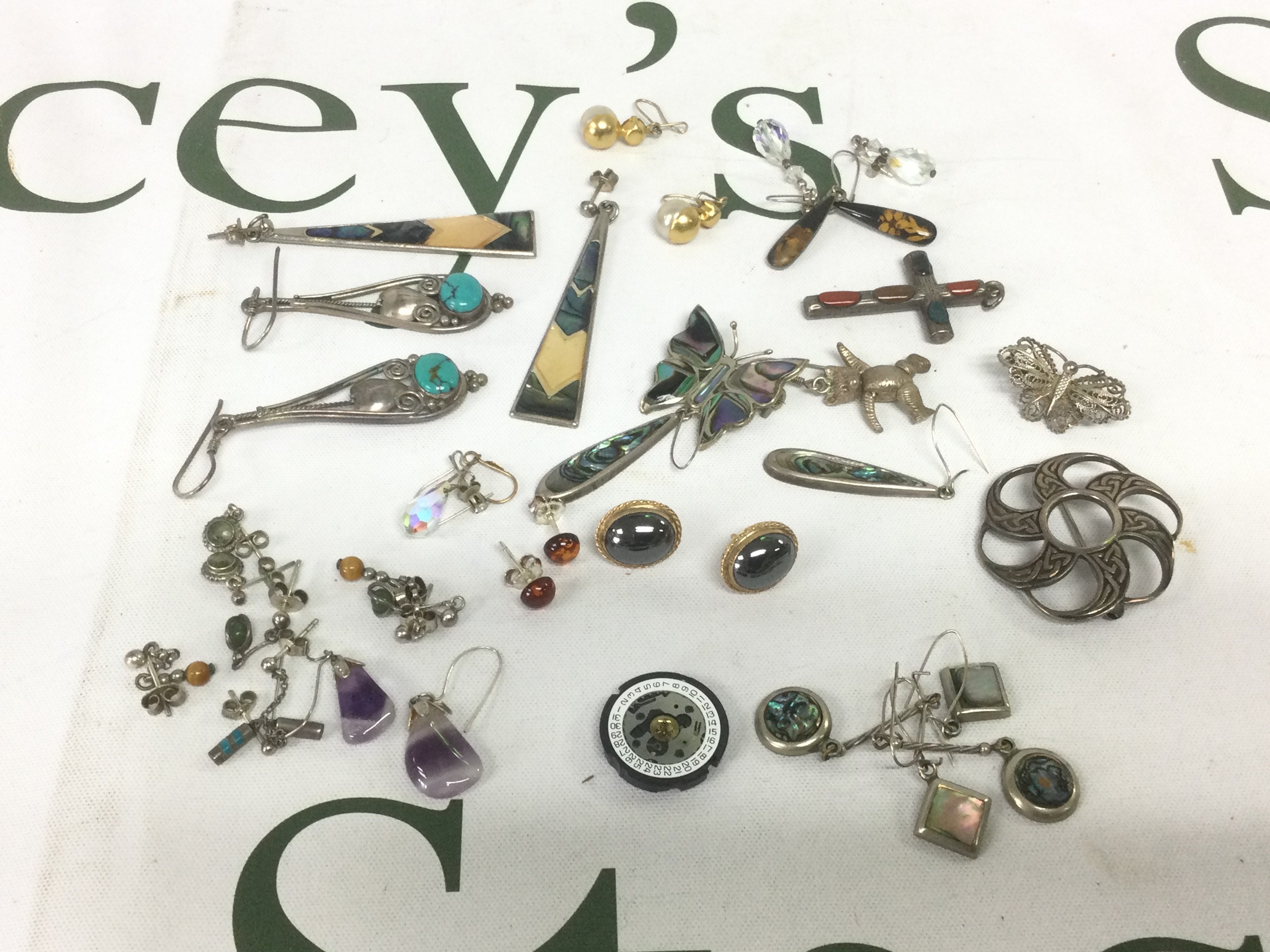 A collection of costume and silver jewellery items comprising earrings, pendants etc. Shipping category A.